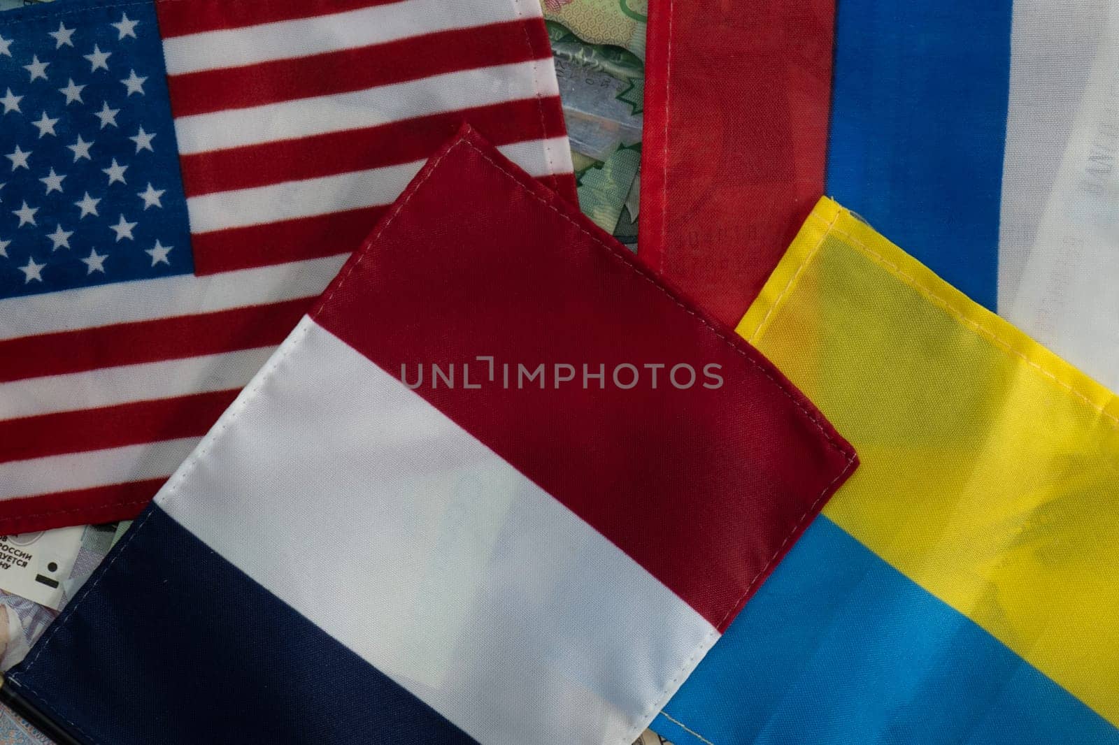 United States, French, Russian and Ukrainian flags on international currencies by bRollGO