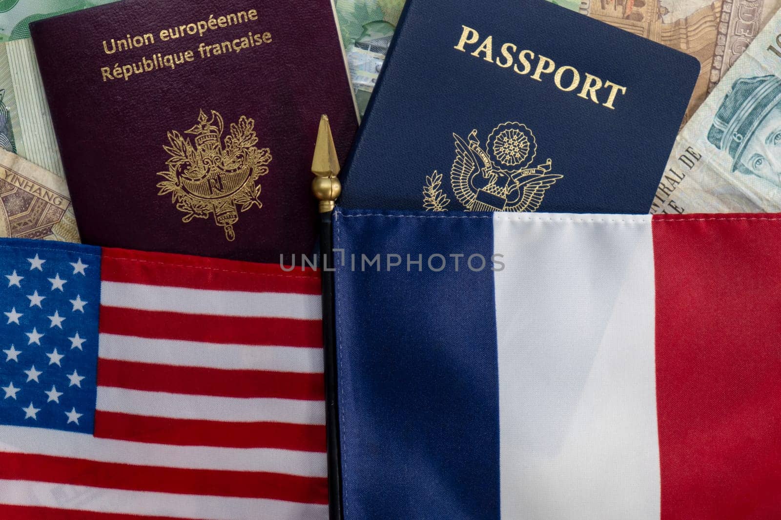 Flags and staff of United States and France on passports and international currency. Concept of fidelity, fellowship, business, trade, employment, vacation travel. Concept coming summer Olympics. Flat lay closeup, selective focus photo high quality photo.