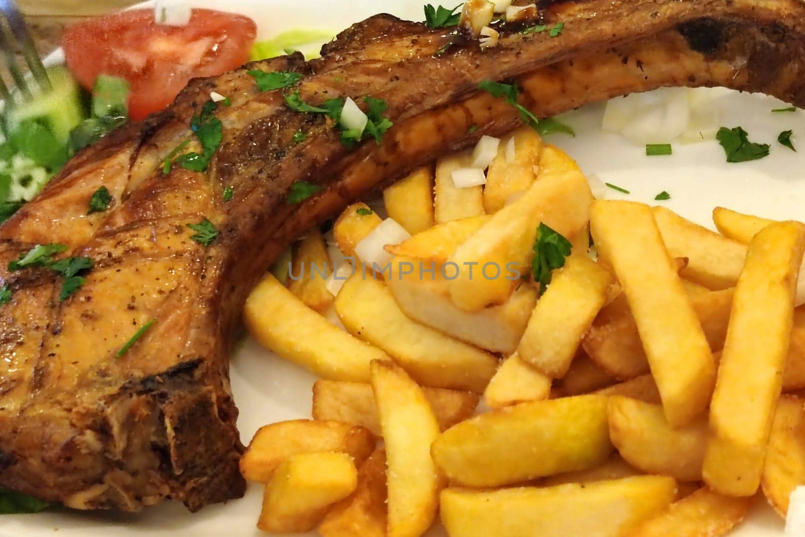 fries with fried pork on the bone by Annado
