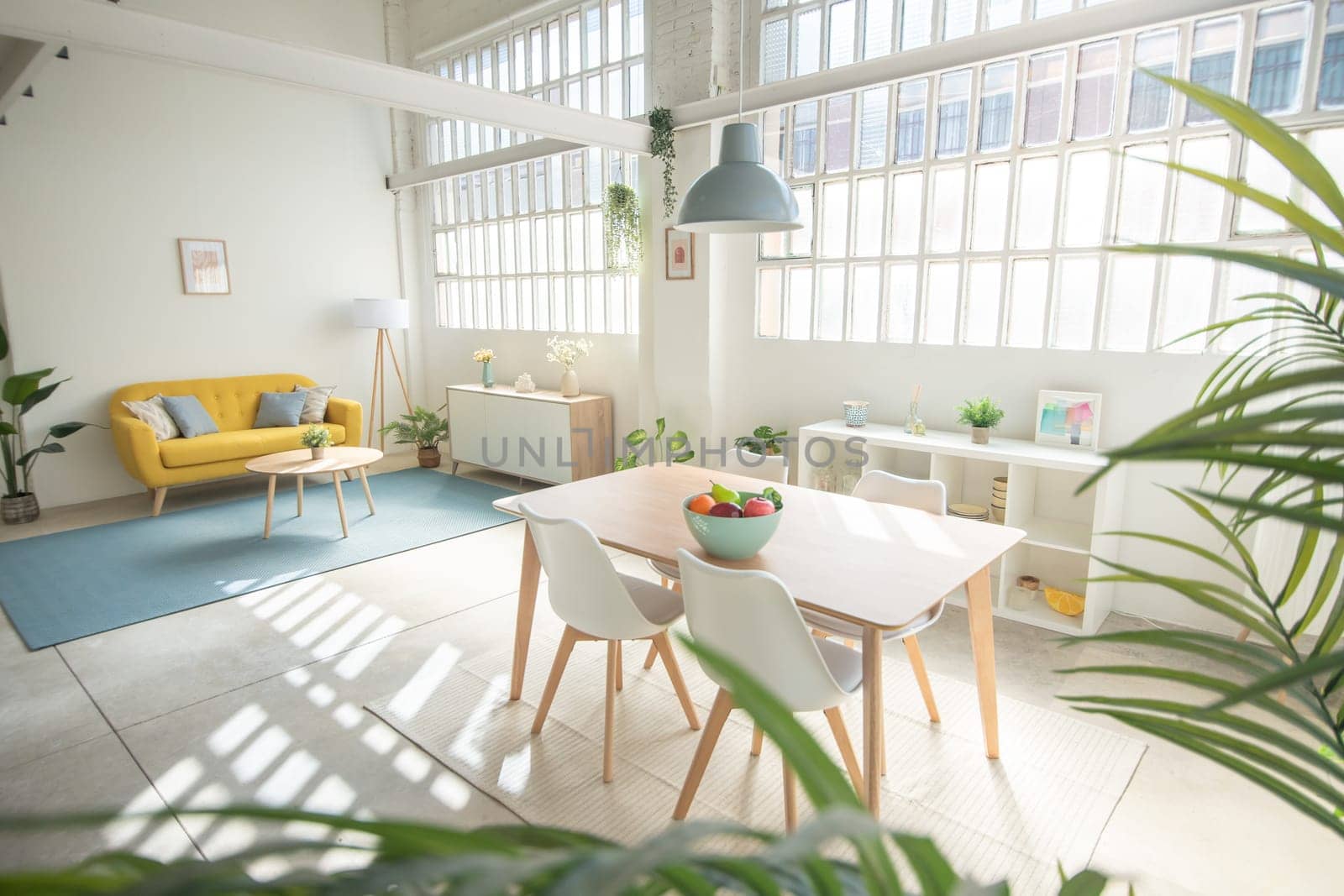 Interior design featuring a yellow couch, table, and chairs in a living room industrial loft. High quality photo