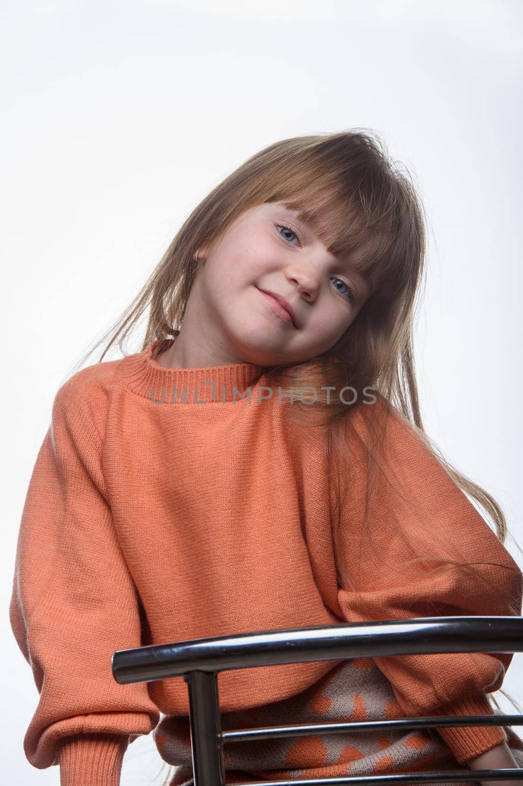 studio portrait of a charming little girl on a white background