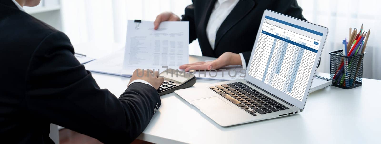 Corporate accountant team use accounting software on laptop to calculate and maximize tax refund and improve financial performance base on financial data. Modern business accounting . Shrewd