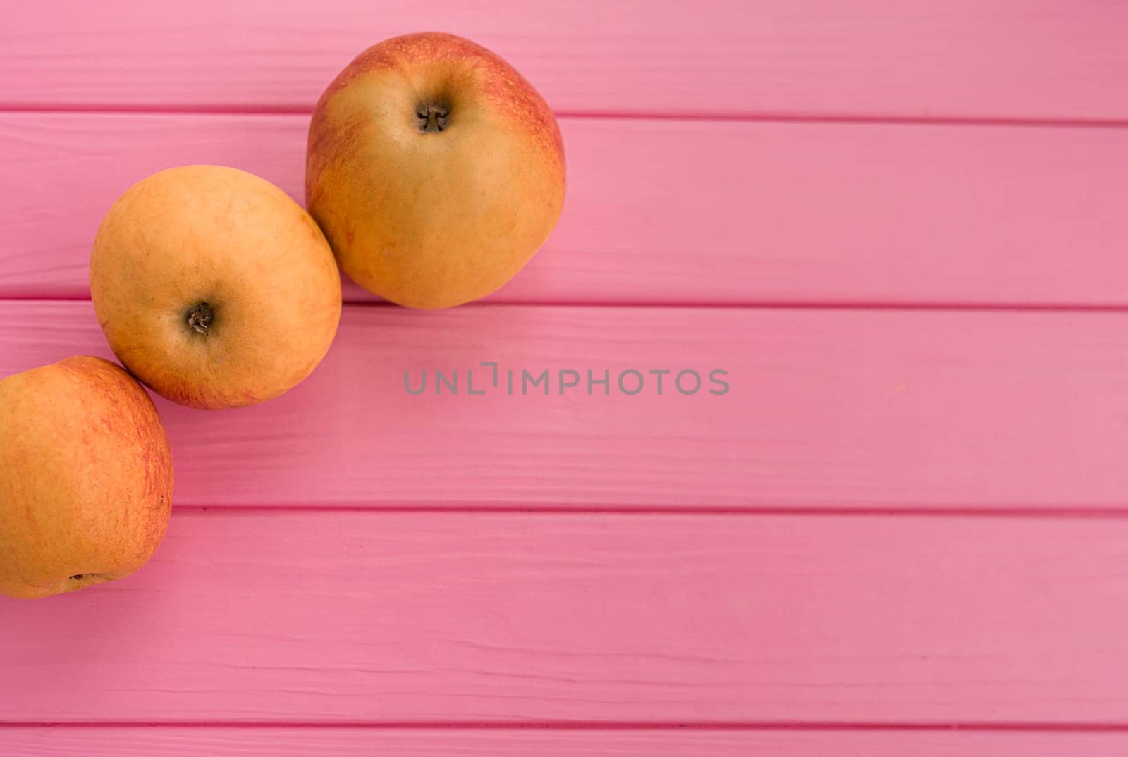 Summer abstract background mockup template free copy space for text pattern sample top view above on pink wooden board. blank empty area for inscription. fresh red apples organic fruits vegetarian