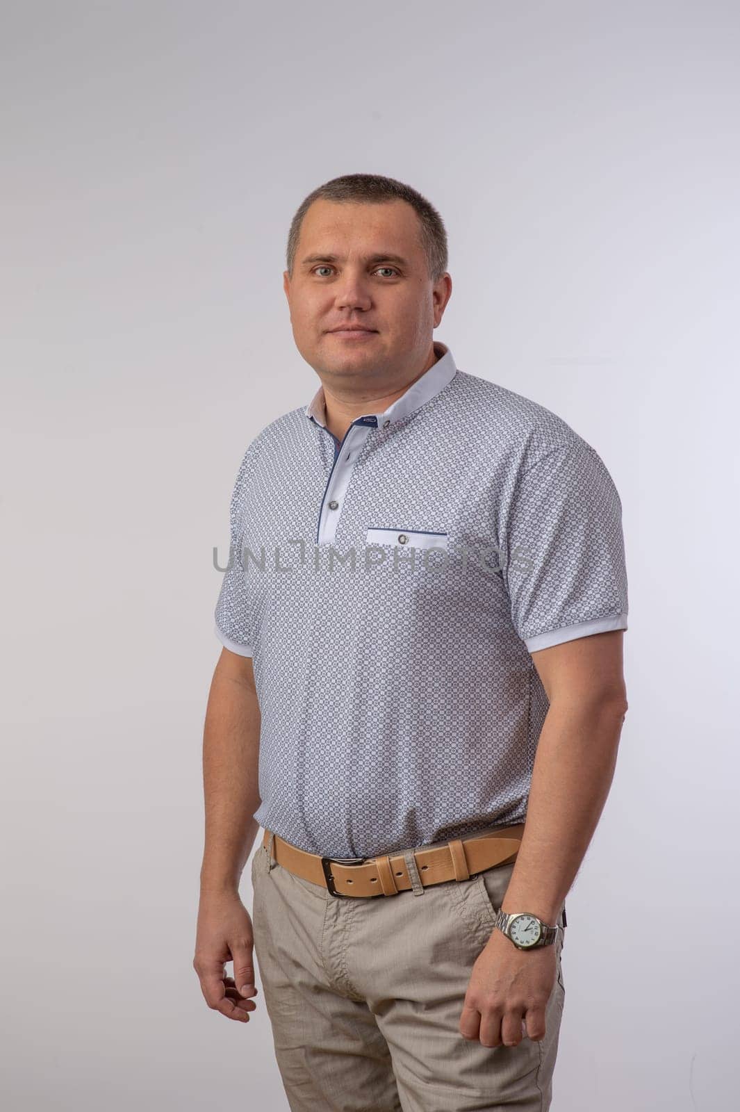 A Portrait of a men in studio gray background