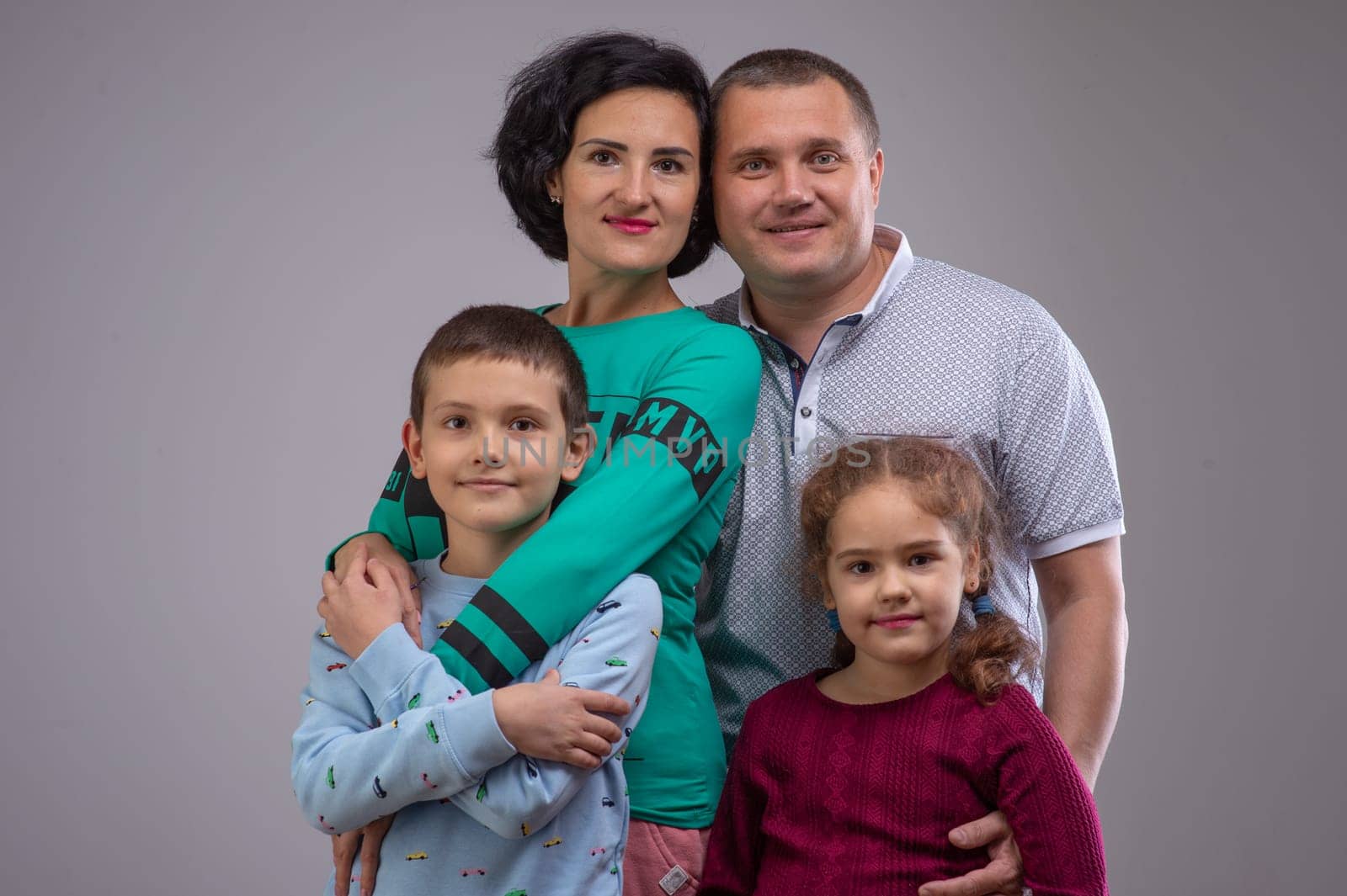 studio portrait of a happy family husband wife daughter and son 8