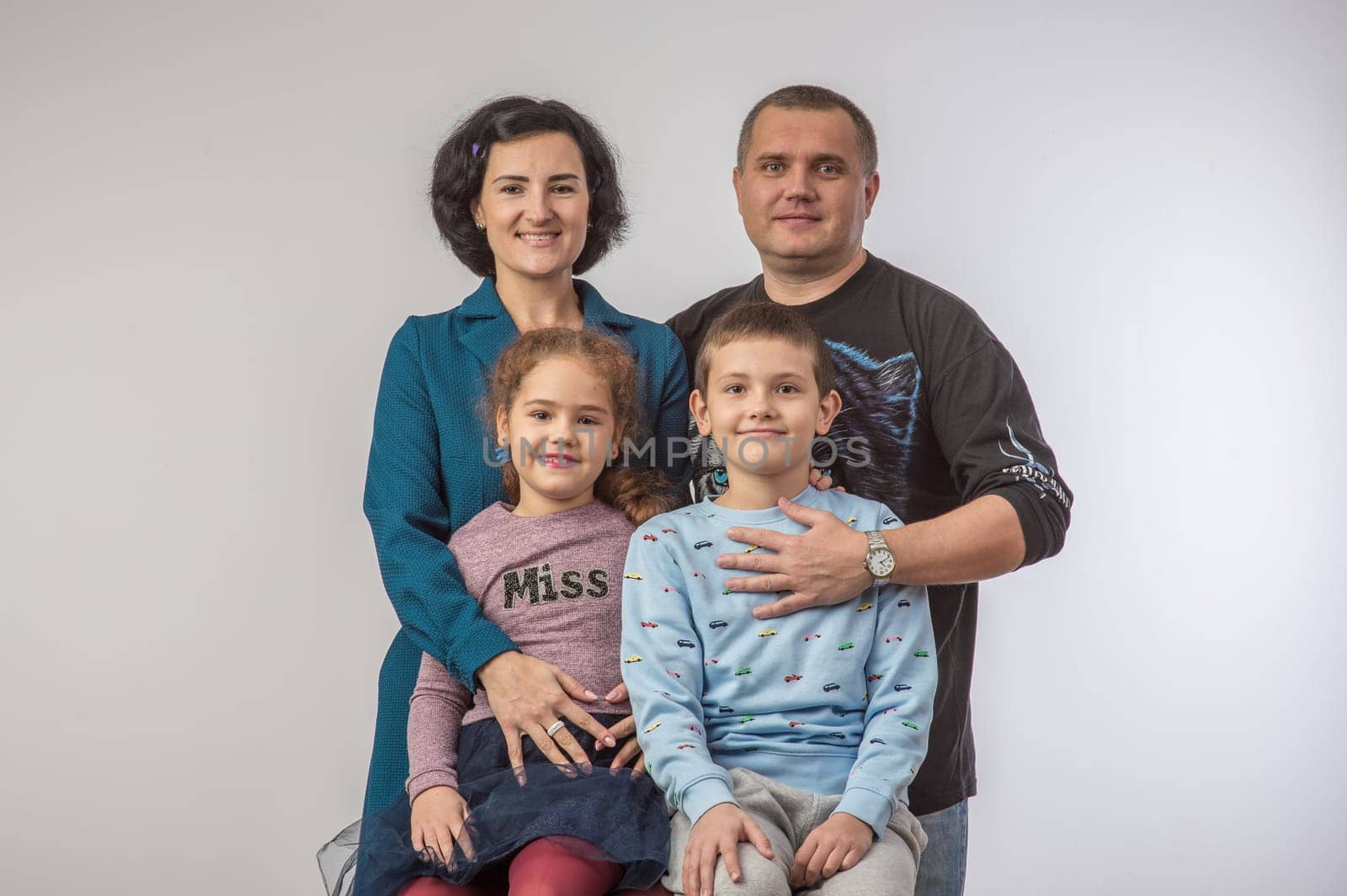 studio portrait of a happy family husband wife daughter and son 6