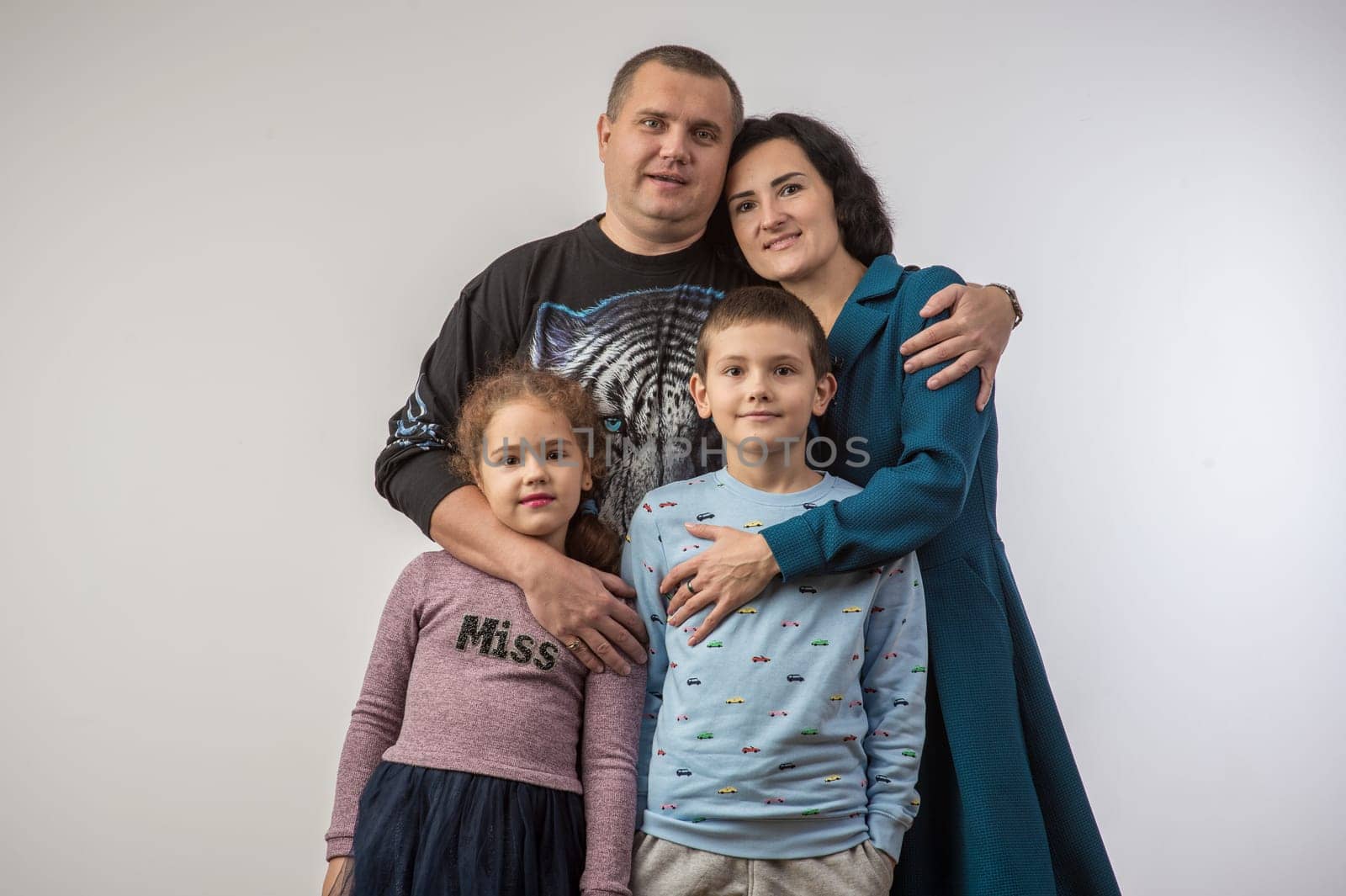 studio portrait of a happy family husband wife daughter and son 2