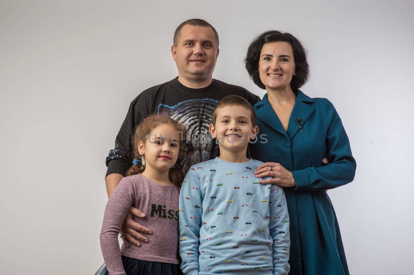 studio portrait of a happy family husband wife daughter and son 1