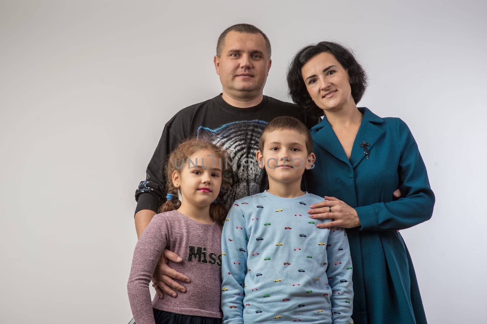 studio portrait of a happy family husband wife daughter and son