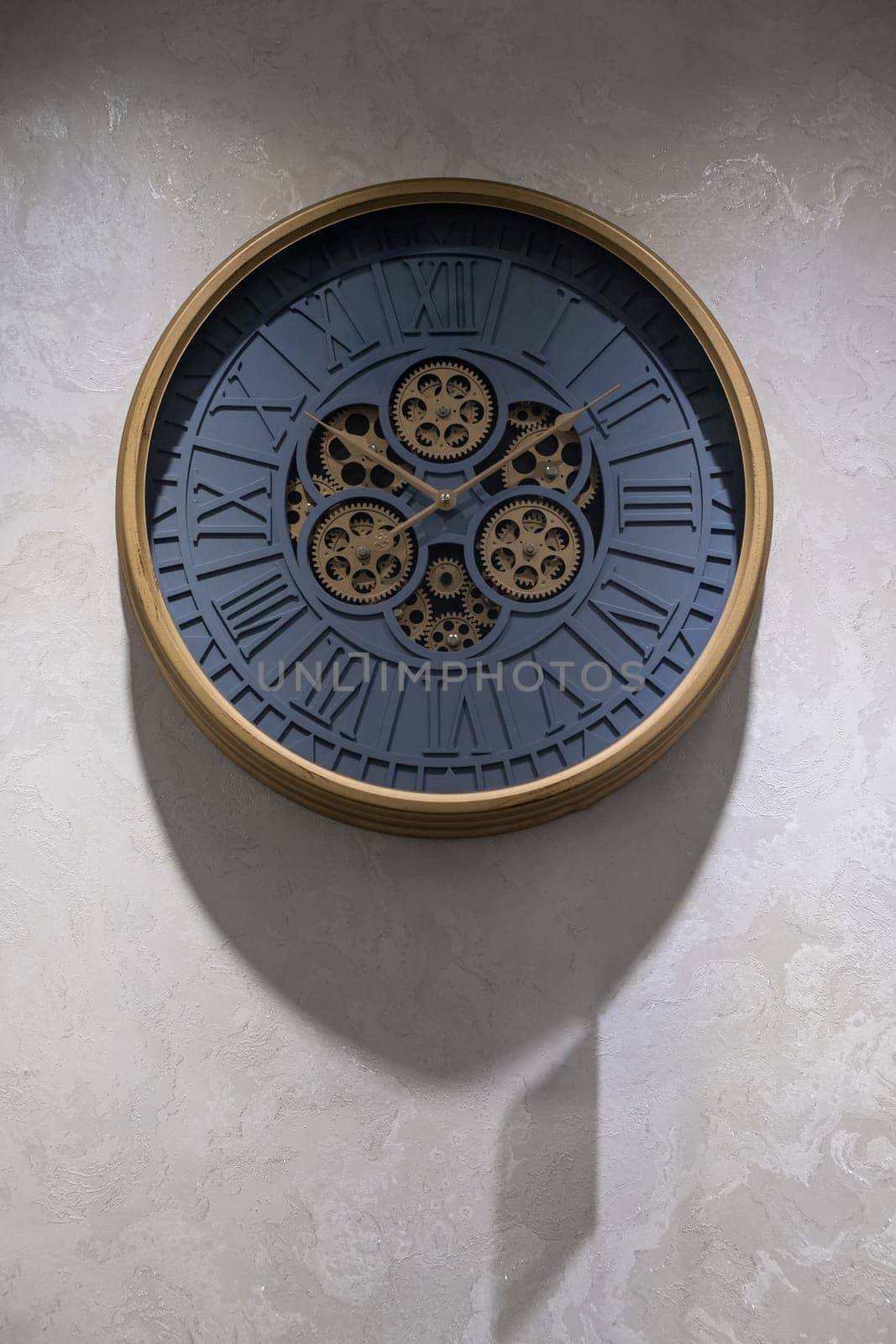 A round clock on the wall indicates the exact time. The decor in the room, copy space.