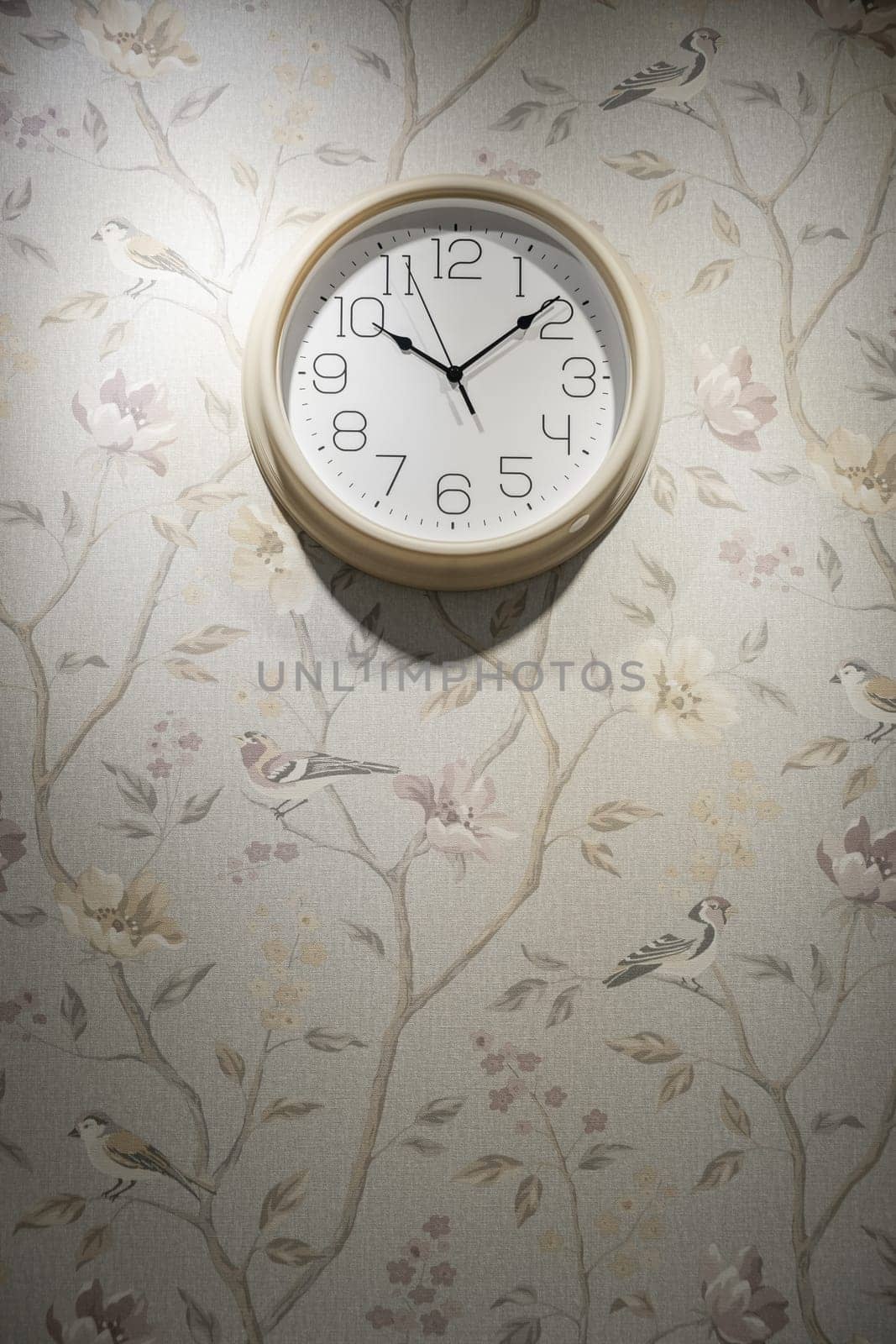 A round clock on the wall indicates the exact time. decor in the room by AnatoliiFoto