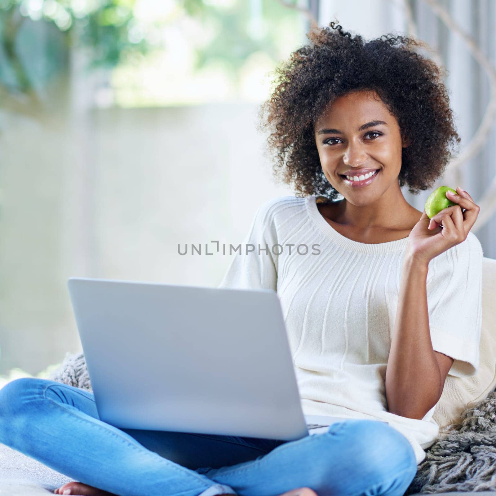 Apple, typing and portrait of woman on sofa with laptop for social media, lifestyle blog and food website at home. Happy female person, technology or fruit for nutrition, healthy diet or clean eating.