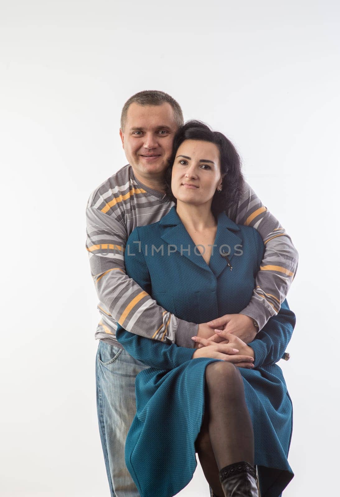 studio portrait of husband and wife happy family