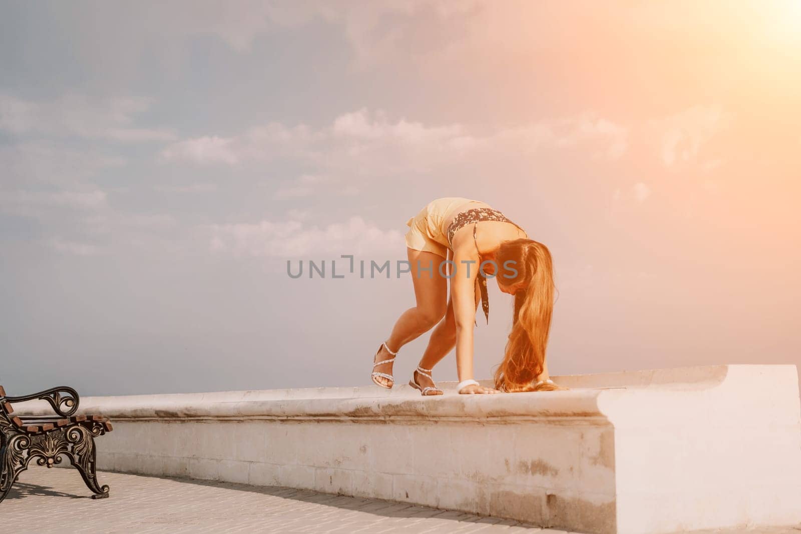 Woman park yoga. Side view of free calm bliss satisfied woman with long hair standing in morning park with yoga position against of sky by the sea. Healthy lifestyle outdoors in park, fitness concept