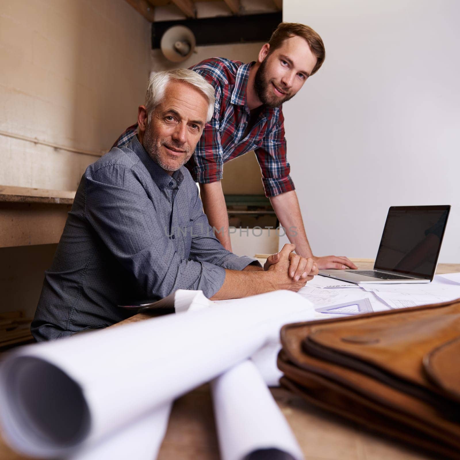 Portrait, men and architecture with blueprint, laptop and teamwork for property development and carpenter. Face, people and entrepreneur with documents and startup with apprentice, industry or mentor.