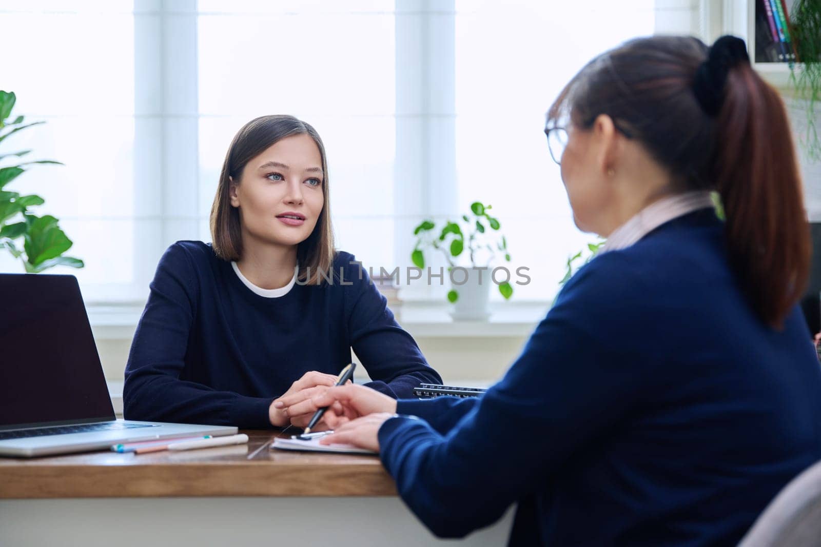 Young woman patient at meeting session with female psychologist therapist social worker counselor psychotherapist. Mental health professional help support treatment psychology psychotherapy counseling