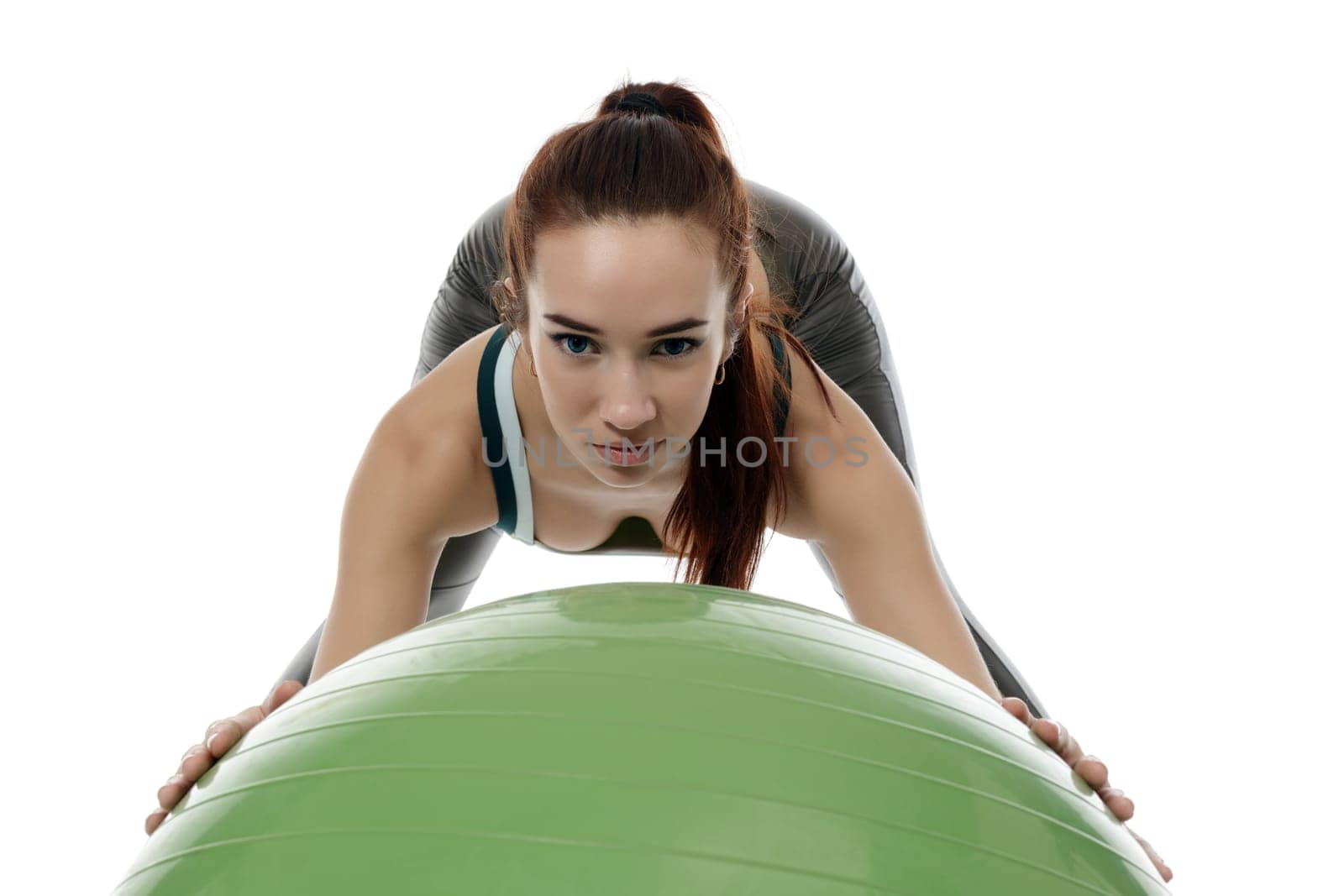 Image of pretty blue-eyed girl training with fitness ball