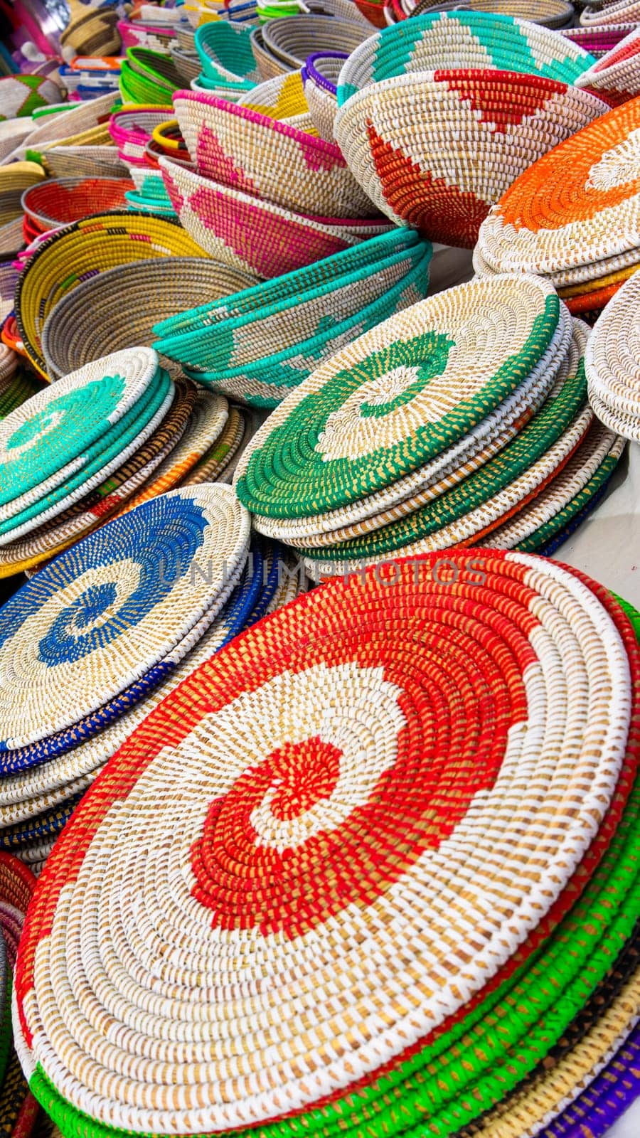 A colorful collection of intricately woven baskets on display