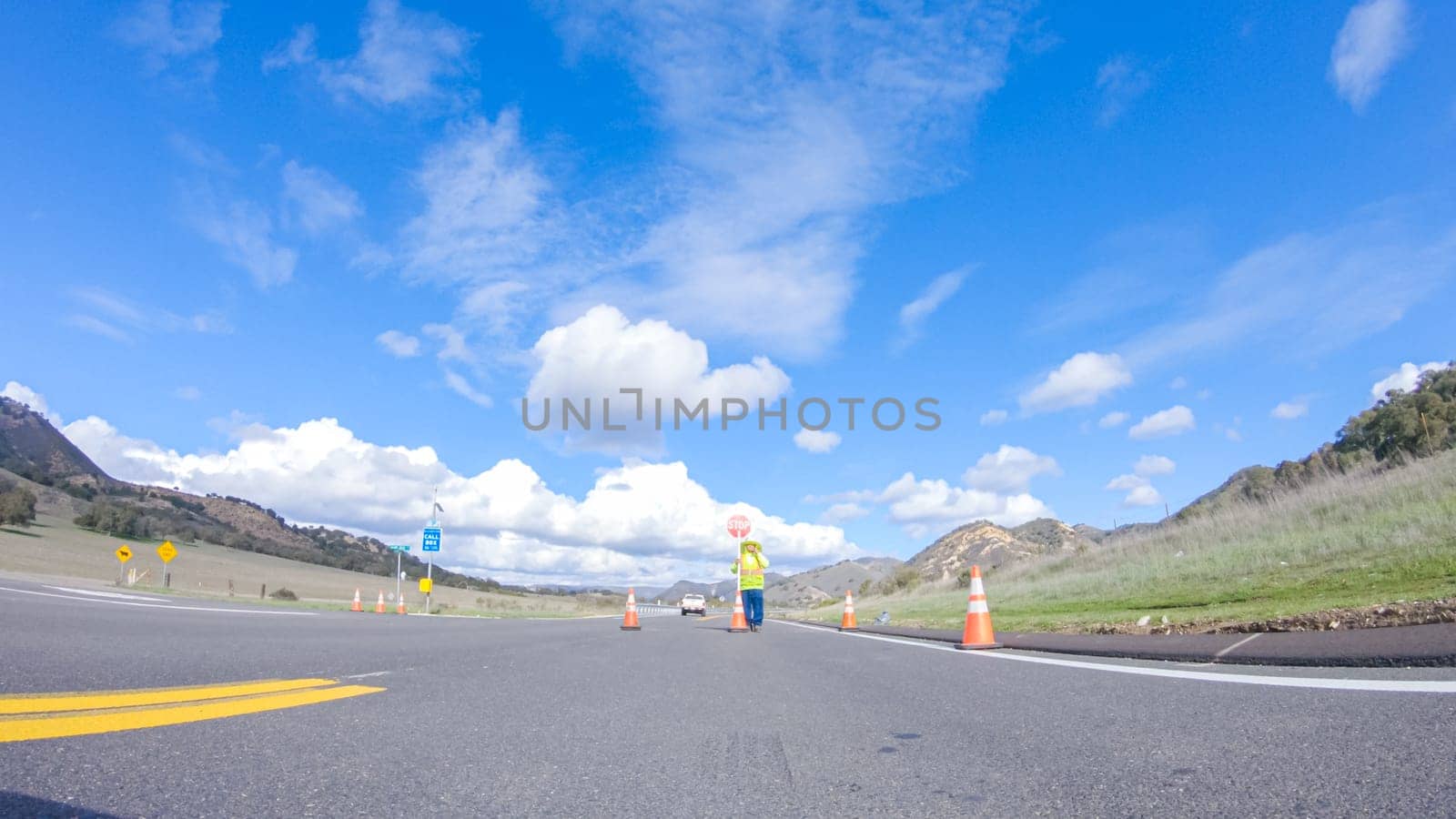 Santa Maria, California, USA-December 6, 2022-Vehicle is cruising along the Cuyama Highway under the bright sun. The surrounding landscape is illuminated by the radiant sunshine, creating a picturesque and inviting scene as the car travels through this captivating area.
