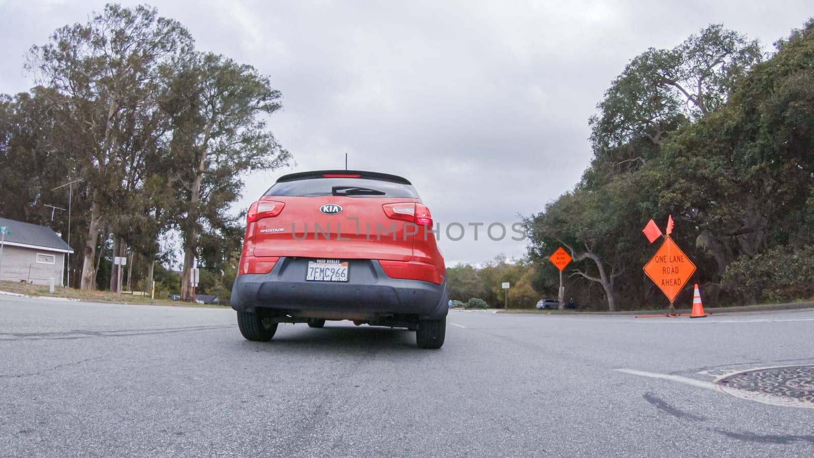 Santa Maria, California, USA-December 6, 2022-Vehicle navigates the streets of Morro Bay, California, during a cloudy winter day. The atmosphere is moody and serene as the overcast sky casts a soft light on the charming buildings and quiet streets of this coastal town.