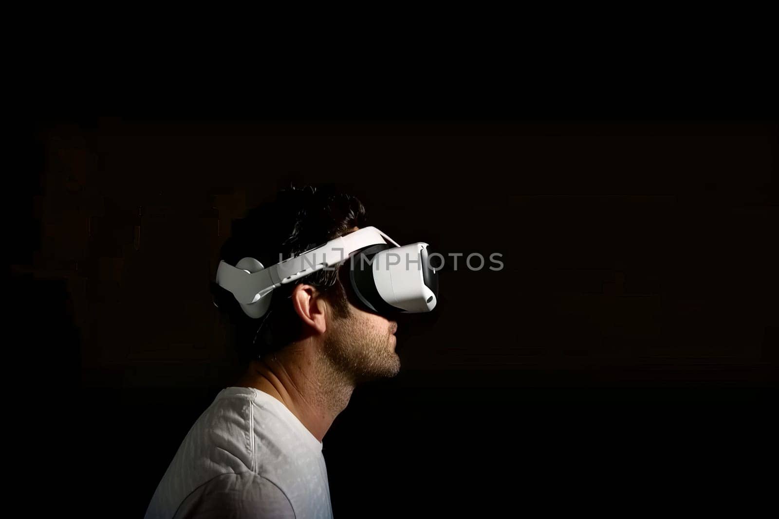 A man wearing a white shirt and a white headband is looking at a screen. Concept of excitement and anticipation as the man prepares to experience a virtual reality game