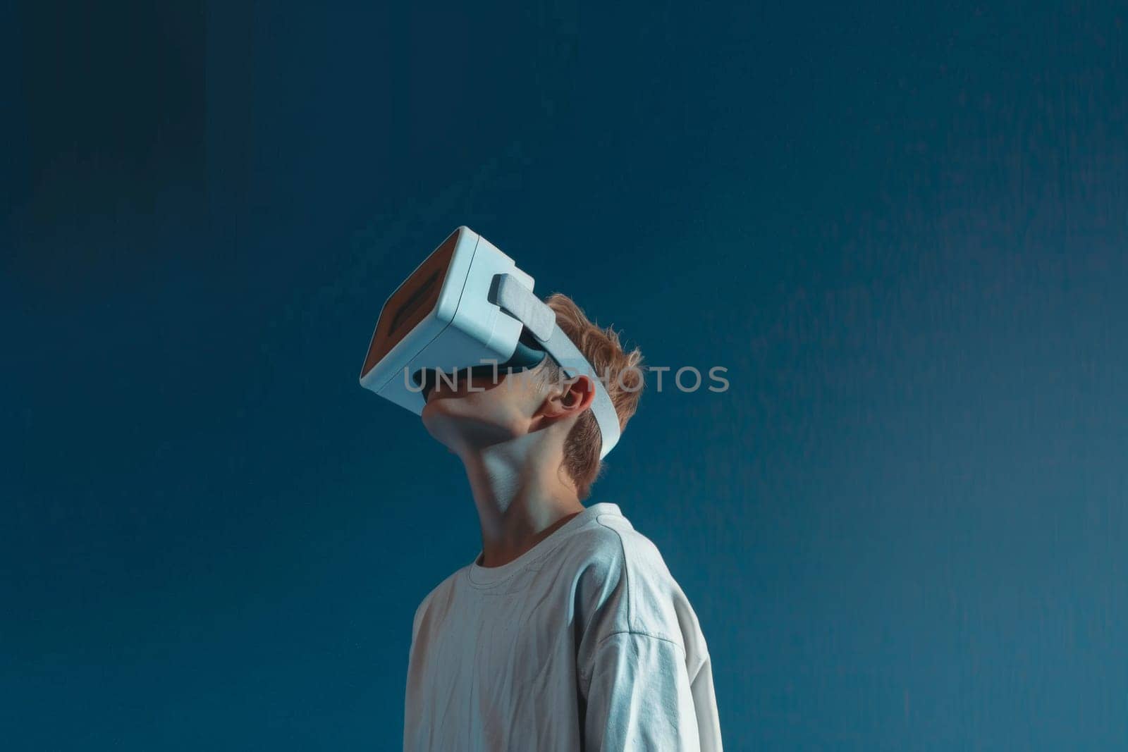 A young man wearing a white shirt and a white virtual reality headset. Concept of excitement and adventure as the man prepares to explore a new virtual world