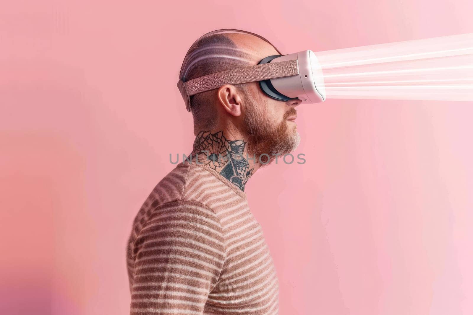 A man with a tattoo on his neck and a white headset on his head. He is looking at a screen with a white light