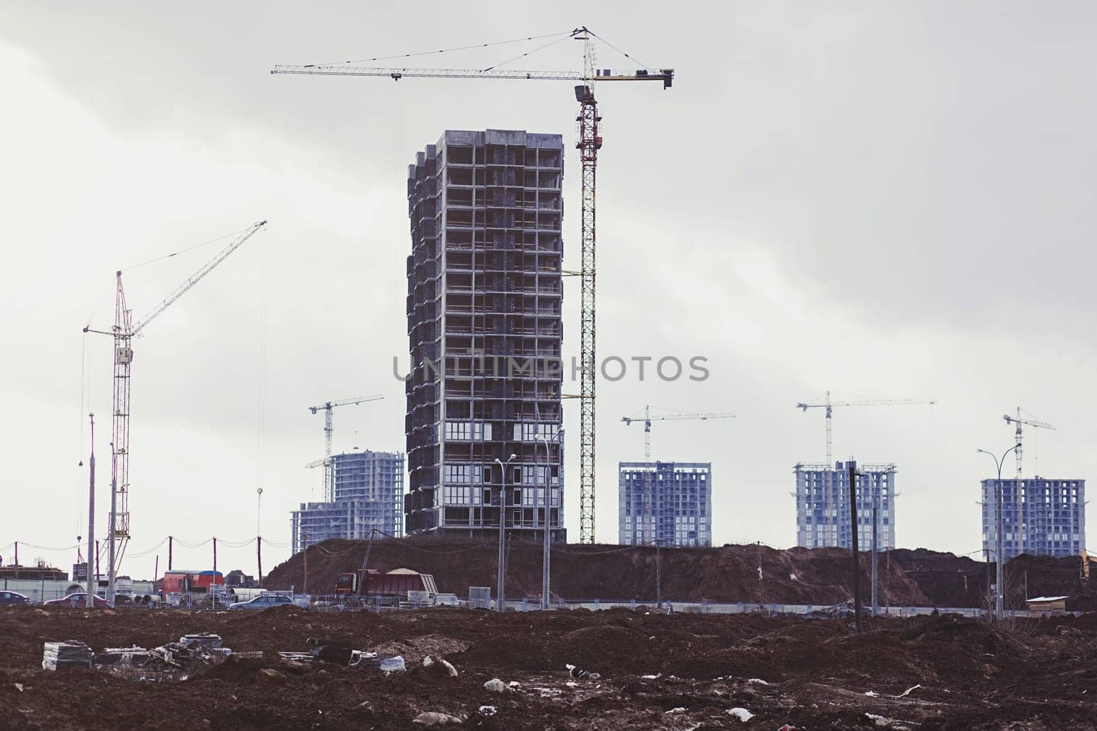 Construction site with cranes of a modern apartment building.