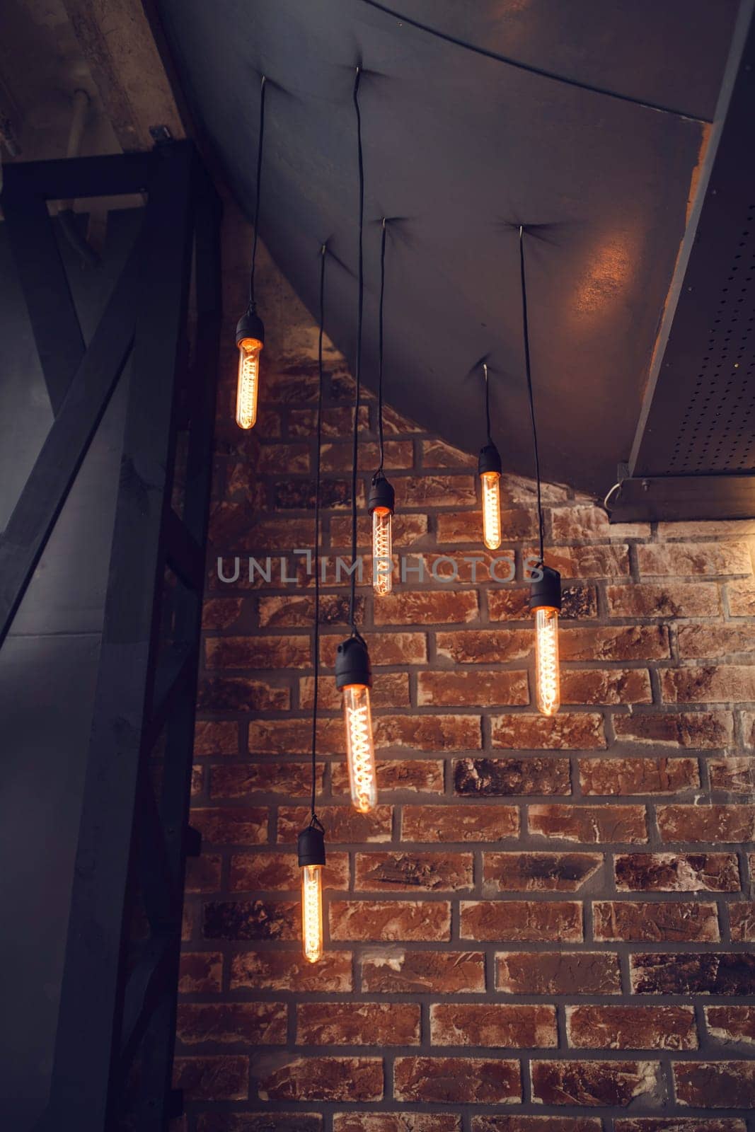 many of hanging lamps in loft cafe interior
