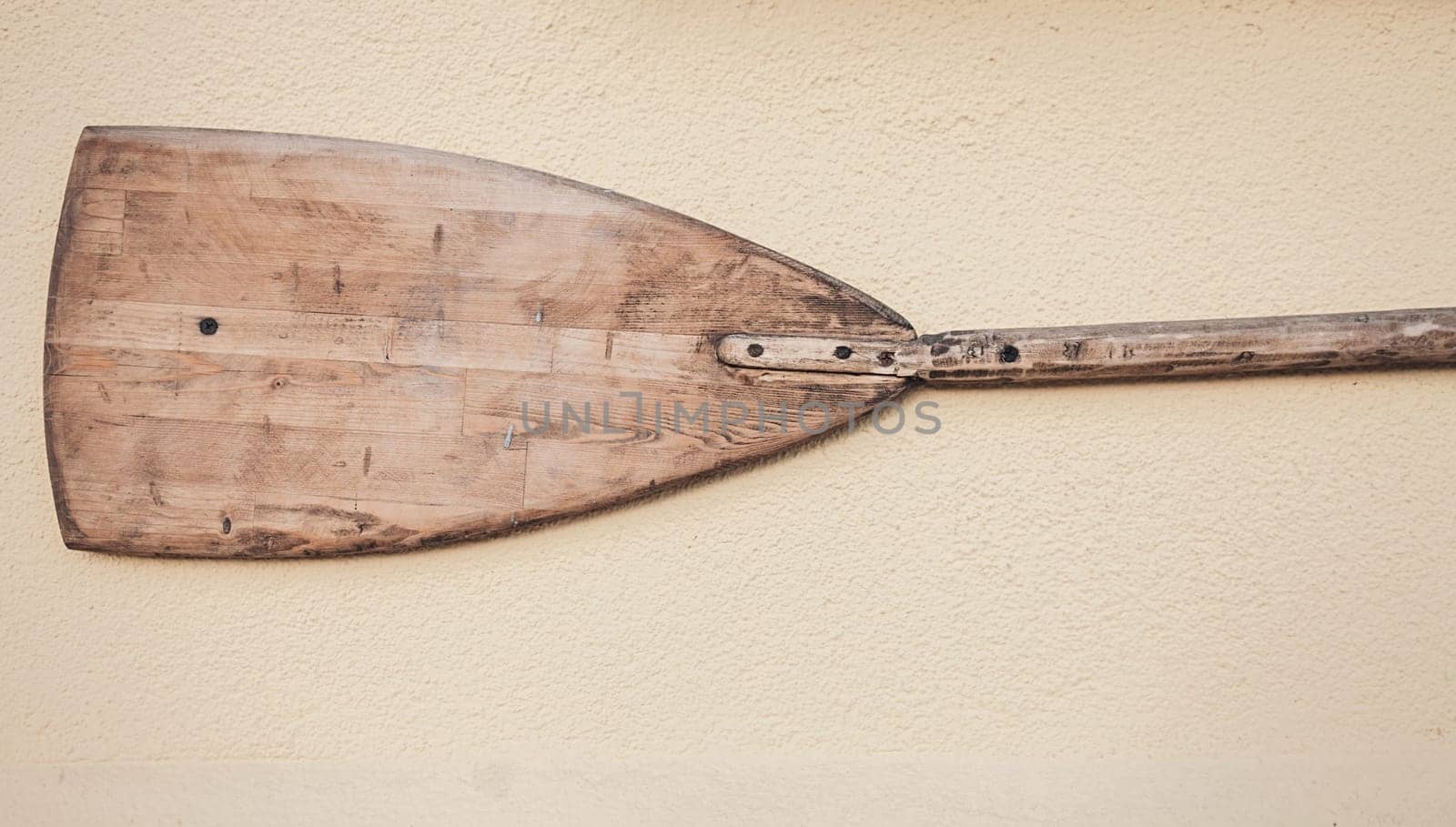 Old wooden canoe paddle on the wall. vintage design