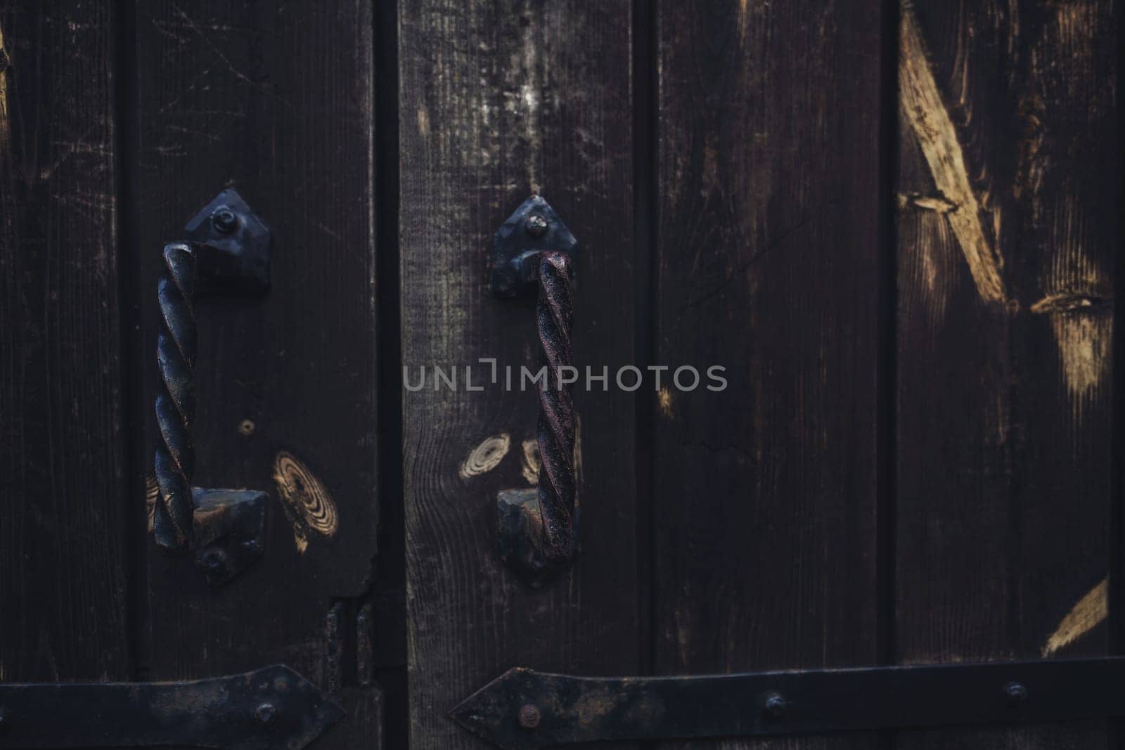 old vintage wooden door with metal handles