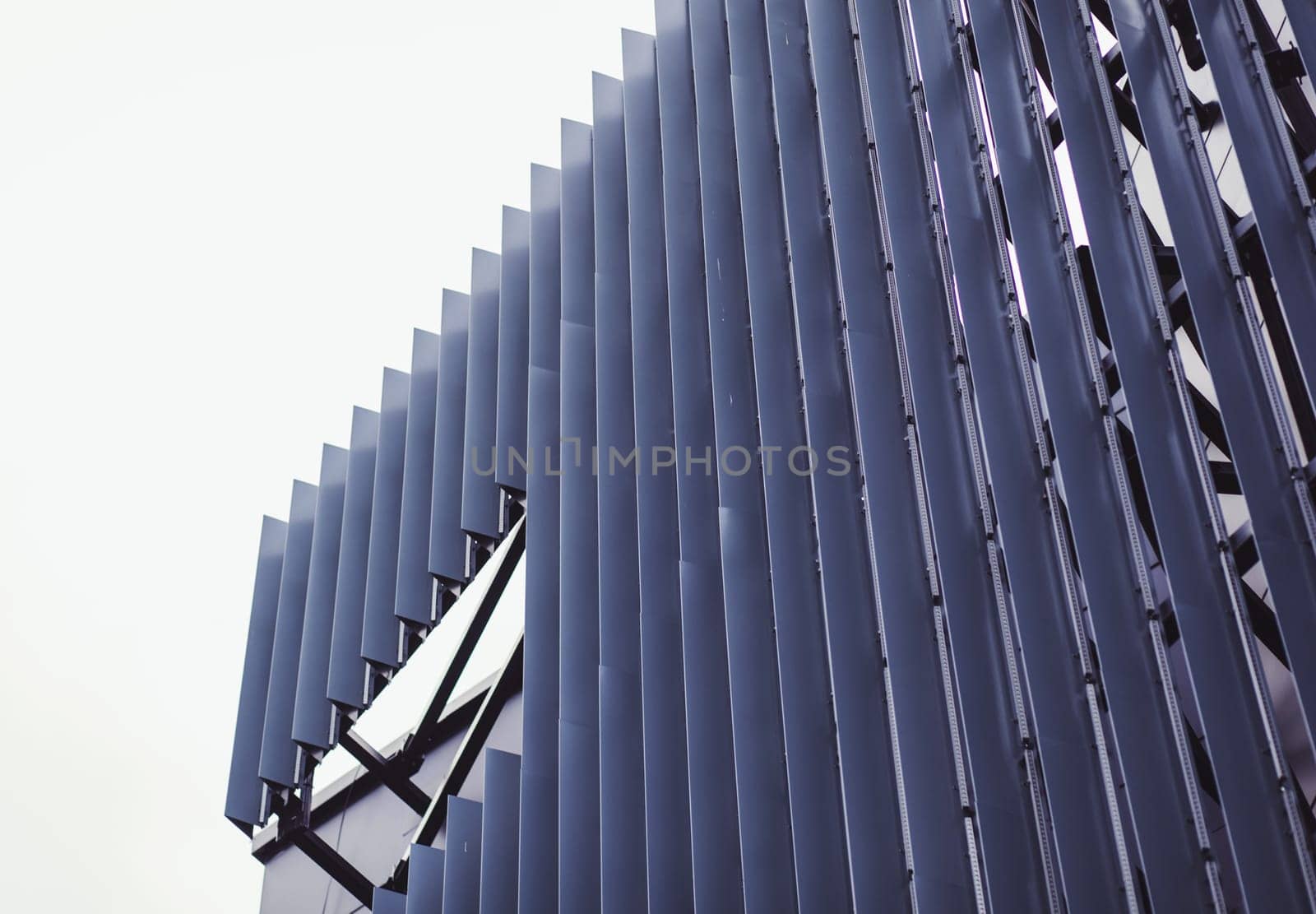 Vertical ,metallic wall panels. Fragment of minimalist business building interior.