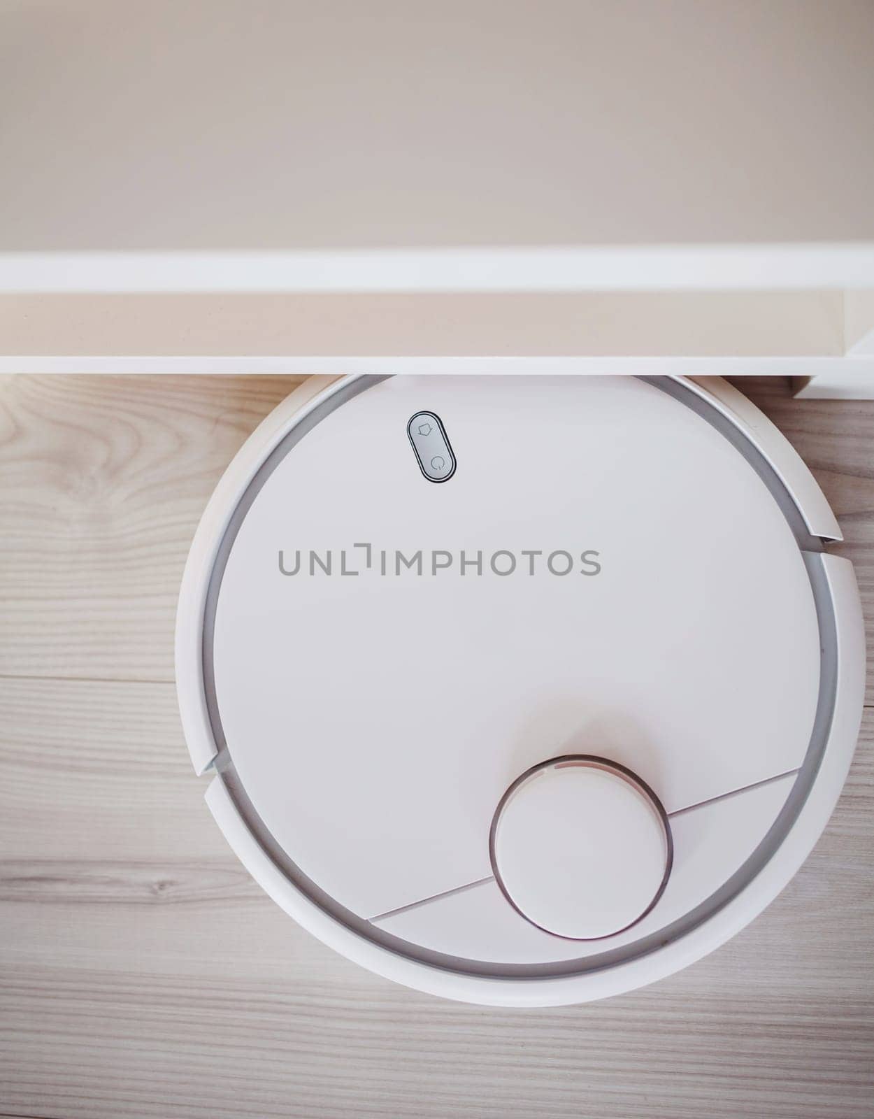Robotic vacuum cleaner working on laminate top view