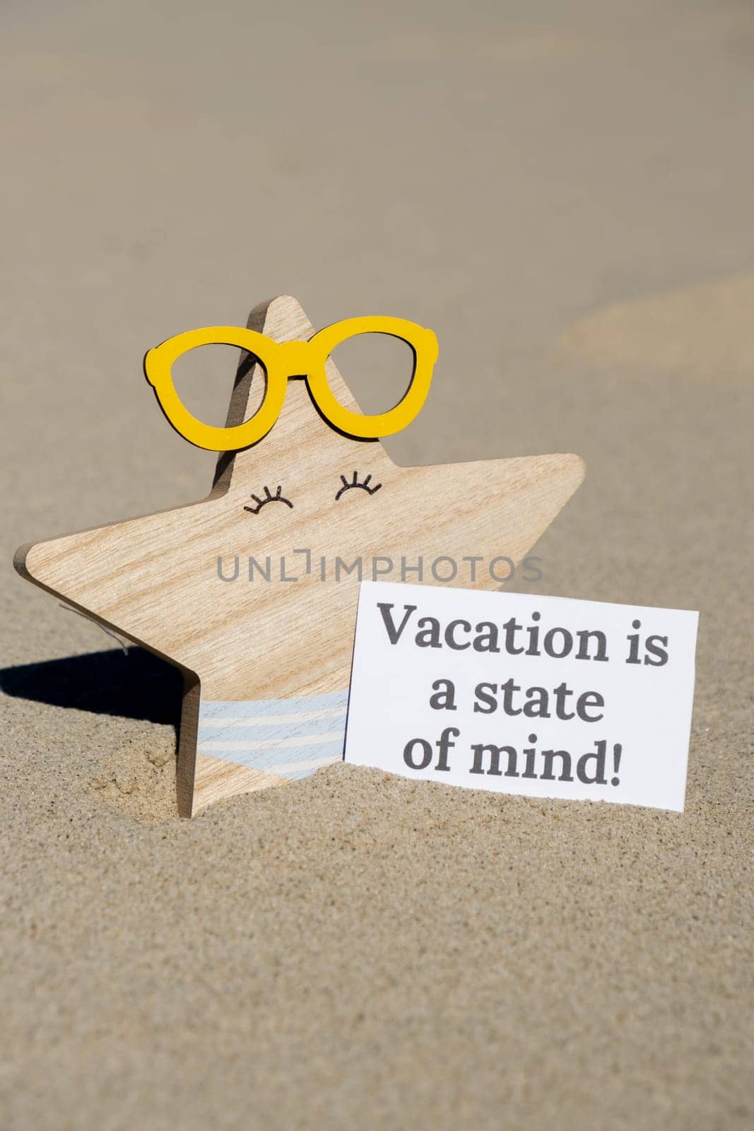 VACATION IS A STATE OF MIND text on paper greeting card on background of funny starfish in glasses summer vacation decor. Sandy beach sun coast. Holiday concept postcard. Getting away Travel Business concept