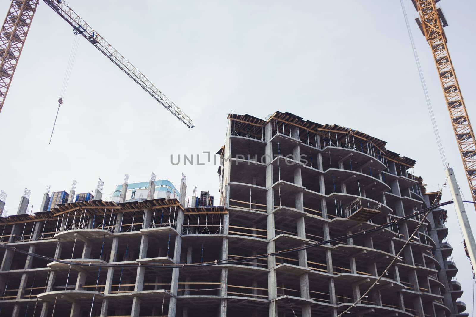 two tower crane on the construction site of a new home. housing loan. mortgage