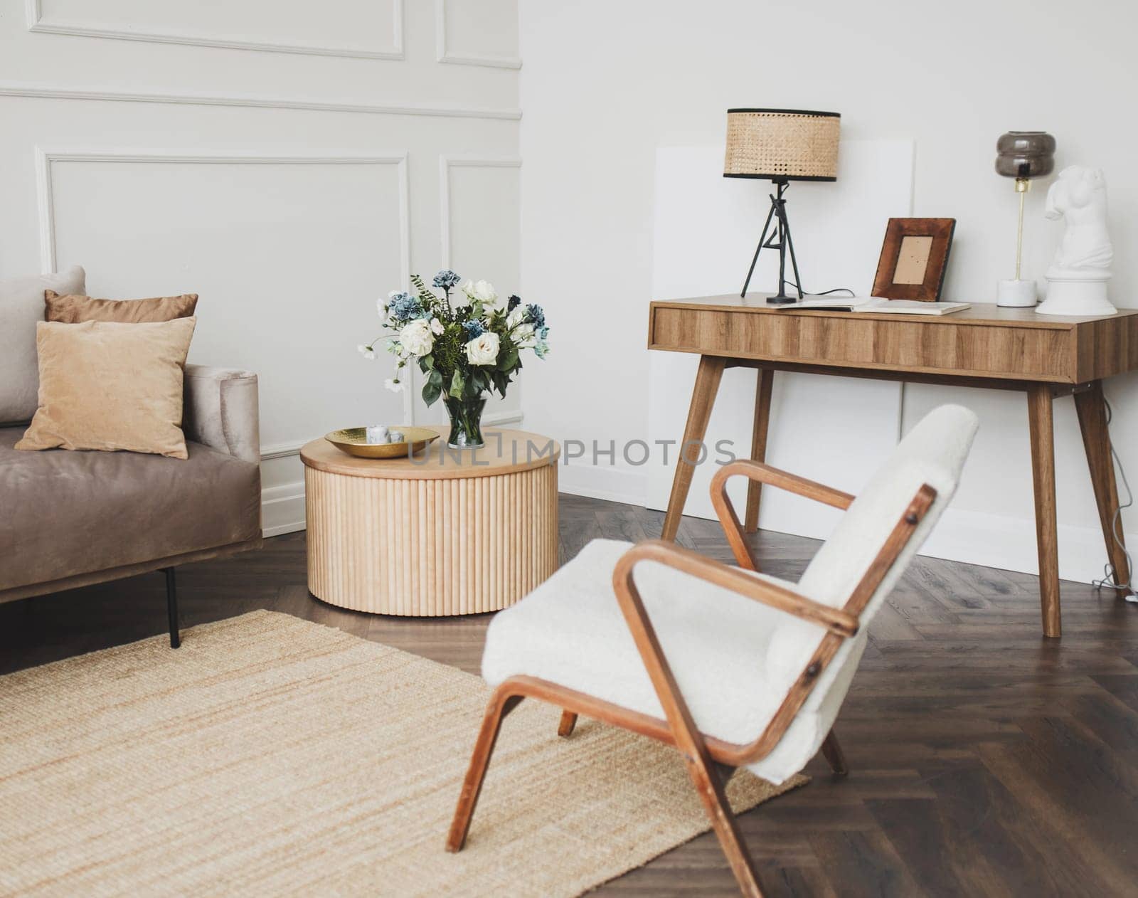 Stylish scandinavian living room, flowers and elegant personal accessories. Modern home decor
