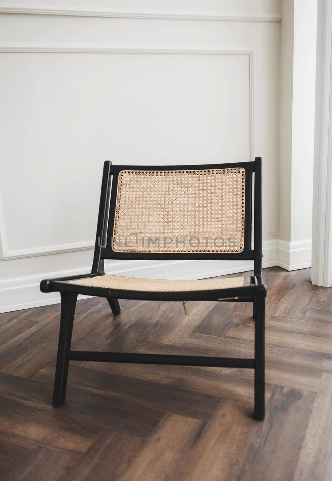 wicker chair in the classic interior by Ladouski