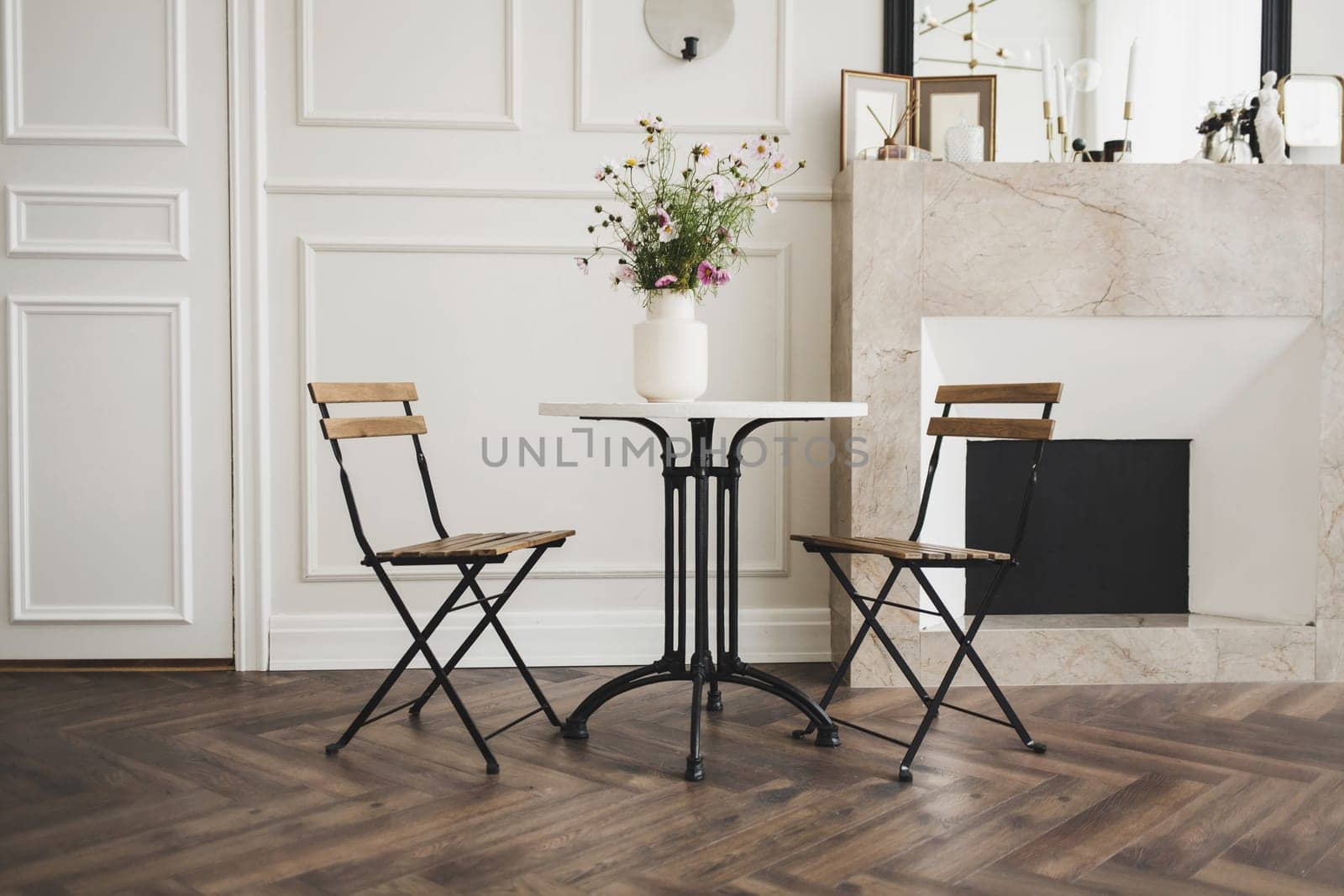 spacious living room with a classic table and chairs in a Scandinavian interior
