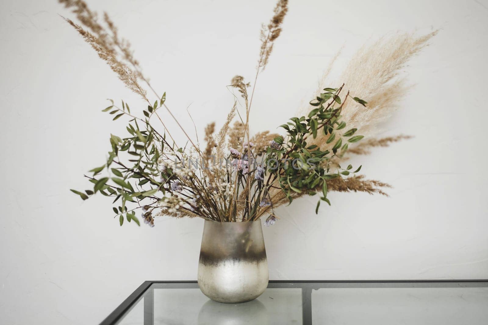 vase with decorative flowers on the table in the room