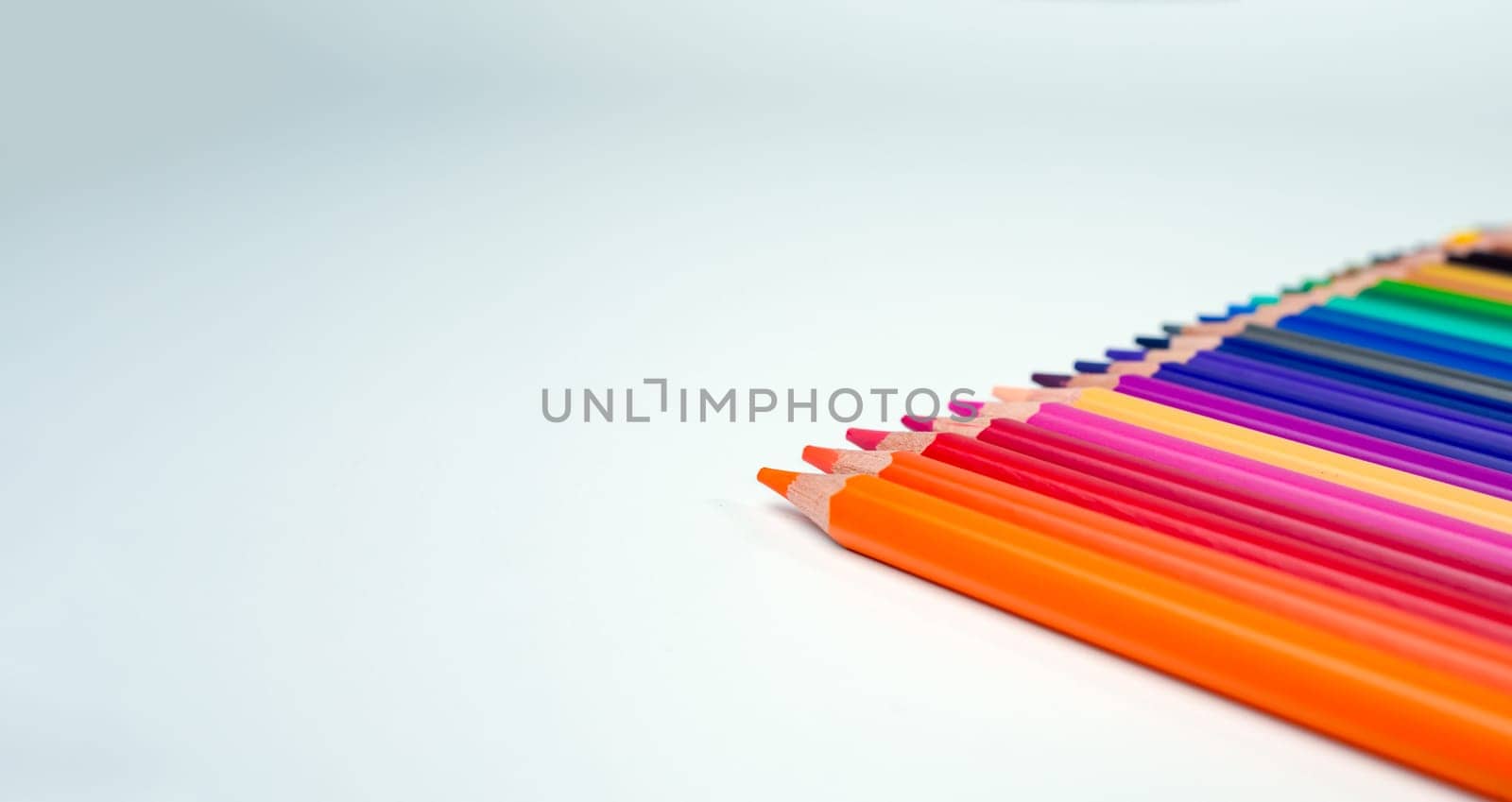 Set of colored pencils on a white background That is arranged in a bar graph, Color pencils on white background, Close up, seamless colored pencils row with wave on lower side, line pencils. by Unimages2527