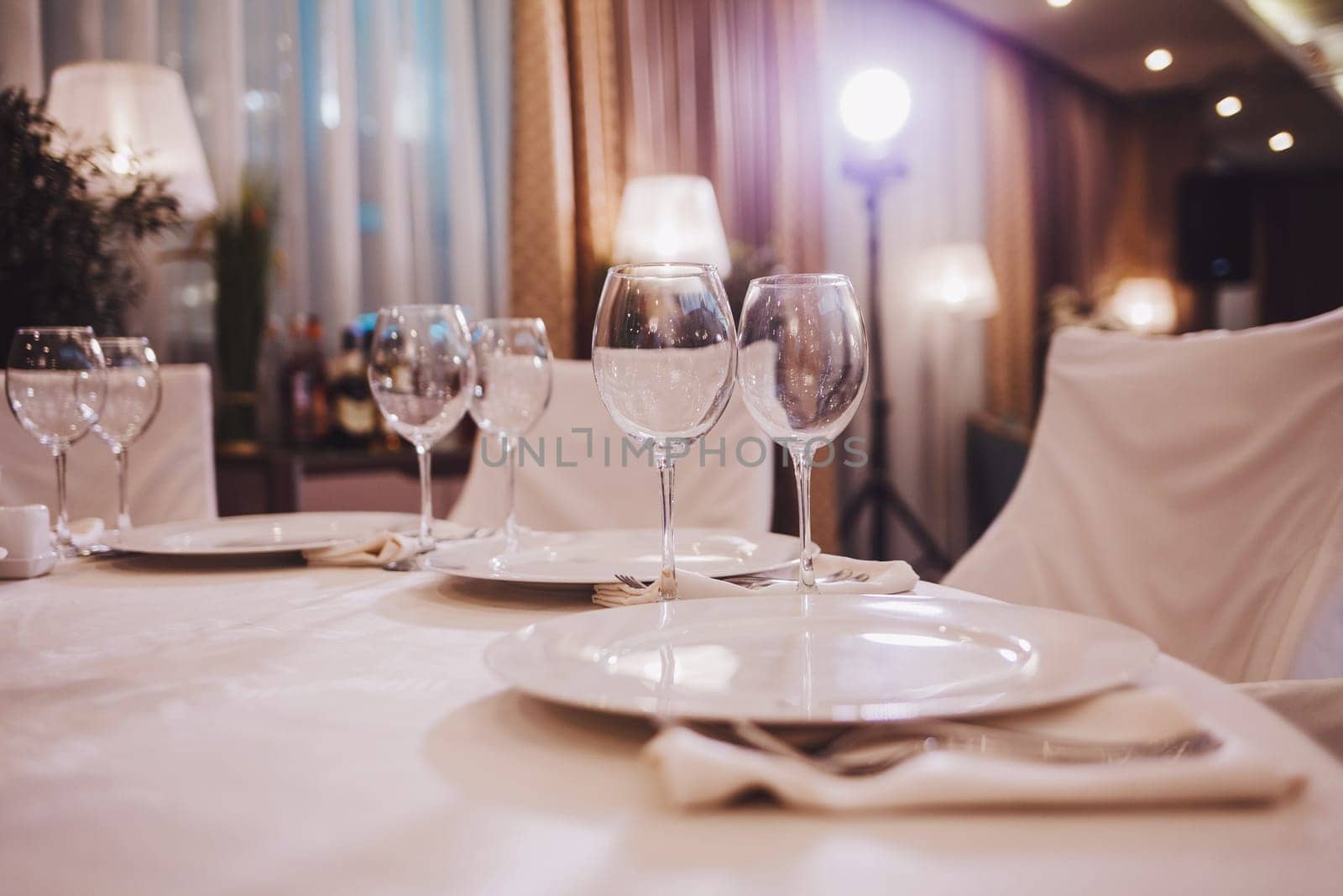 champagne glasses and plates in the restaurant. wedding dinner