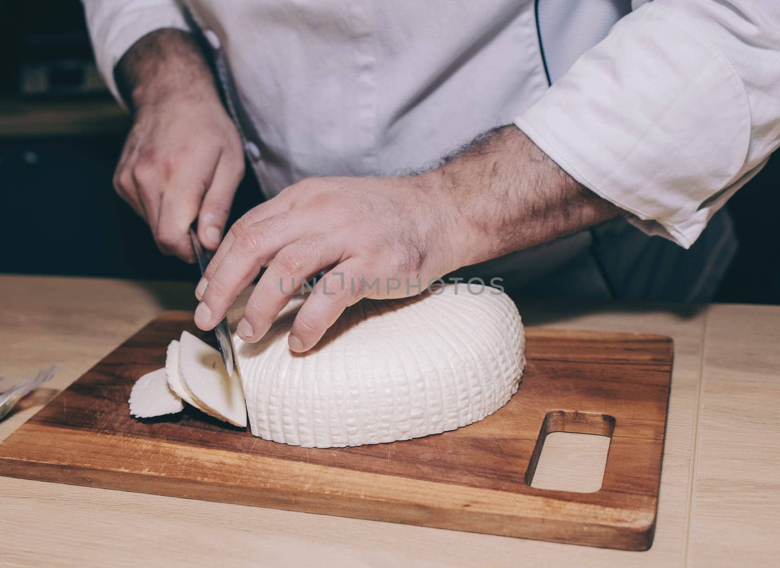 the cheese is kept in the male hands of the chef cook