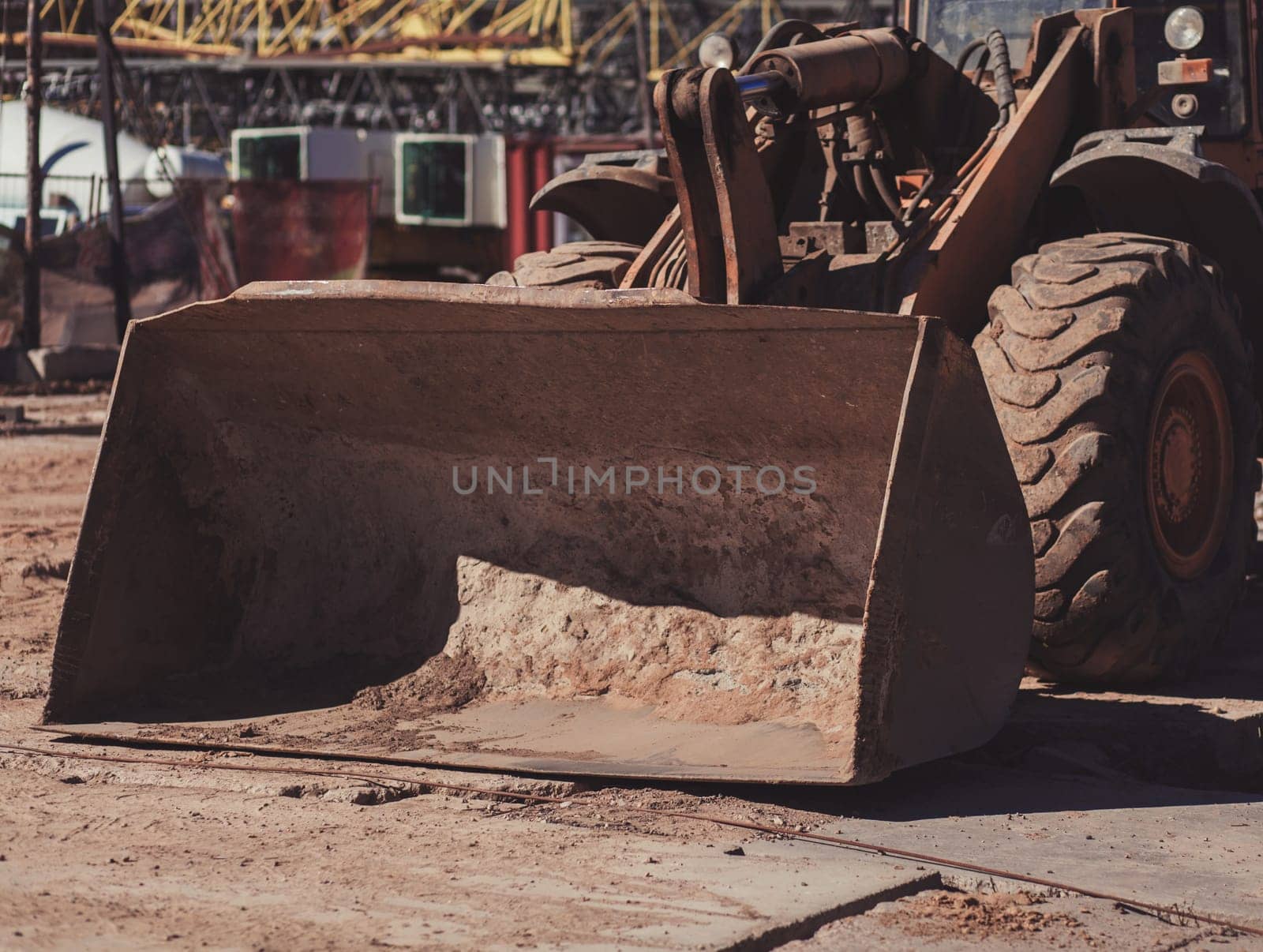 Wheel loader with a large bucket on the construction site. Transportation of materials