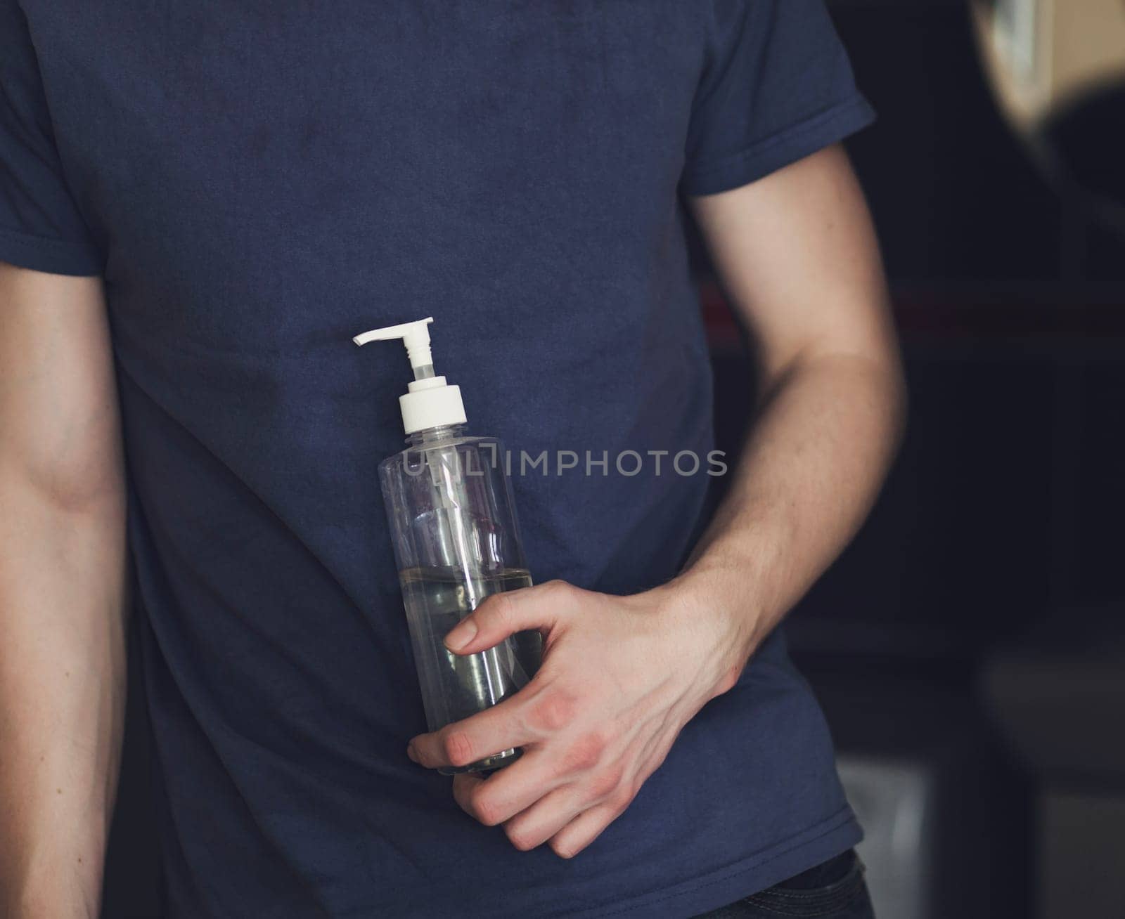 man is holding an antibacterial hand gel. protection from coronavirus. hygiene and health