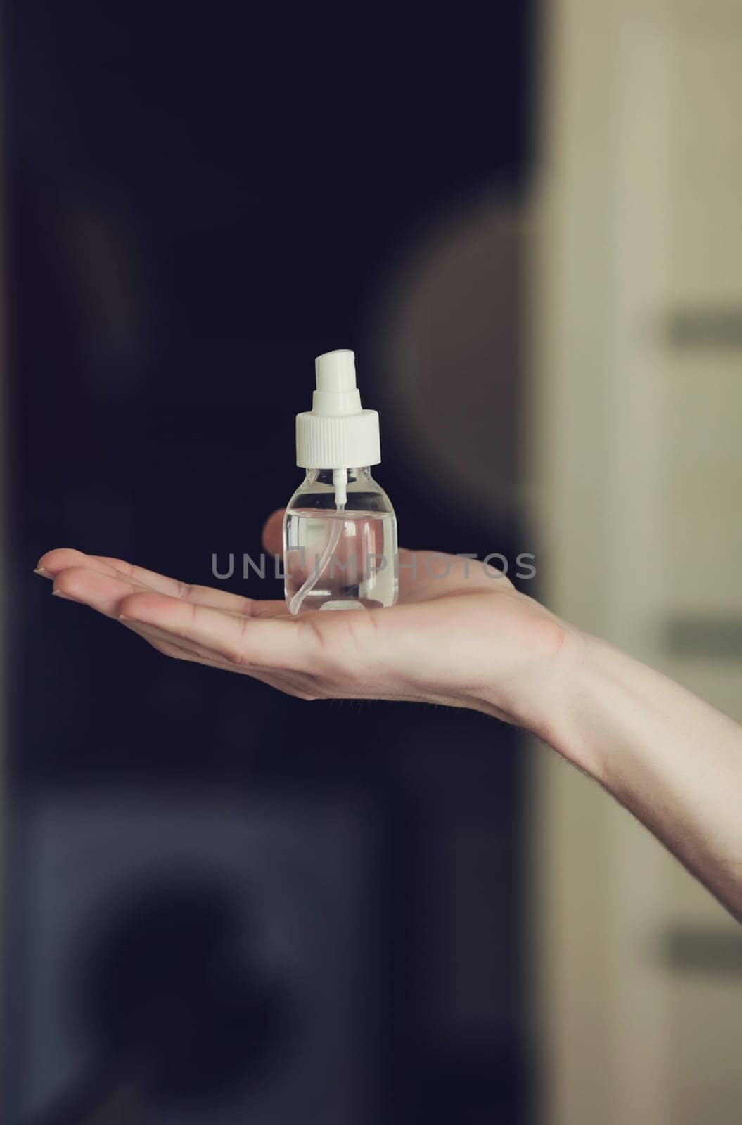 hand with an alcohol-based hand-washing spray as a preventive hygiene measure against coronavirus. Antibacterial hand sanitizer gel.