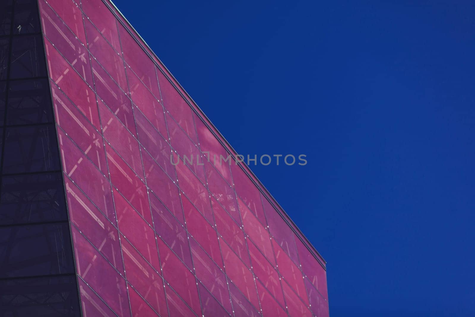 modern urban architecture. red office glass building against the sky