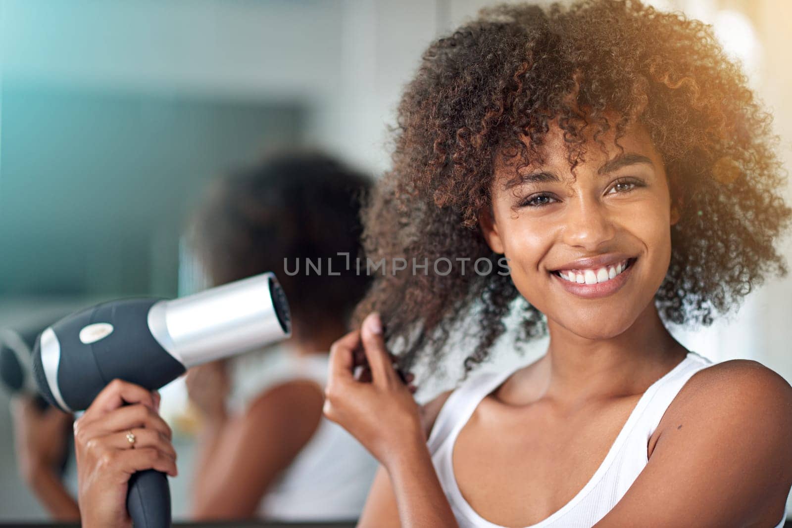 Black woman, hairdryer and hair with texture in portrait, curly hairstyle or frizz for morning routine in bathroom. Natural beauty, haircare and heat treatment for growth, shine and cosmetics at home by YuriArcurs