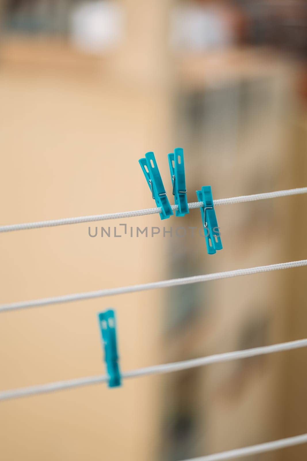 Blue Clothes Pins Are Hanging On A Clothes Line with urban background