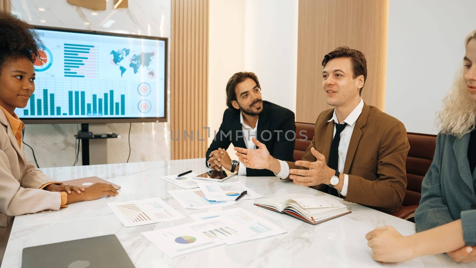 Analyst team utilizing BI Fintech to analyze financial data at table in ornamented meeting room. Businesspeople analyzing BI dashboard power for business insight and strategic marketing planning.