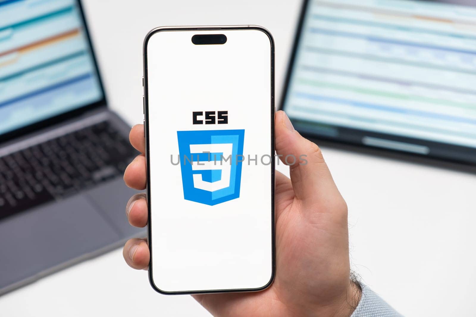 PRAGUE, CZECH REPUBLIC - JANUARY 21 2024: CSS logo on the screen of smartphone in mans hand on the workplace background.
